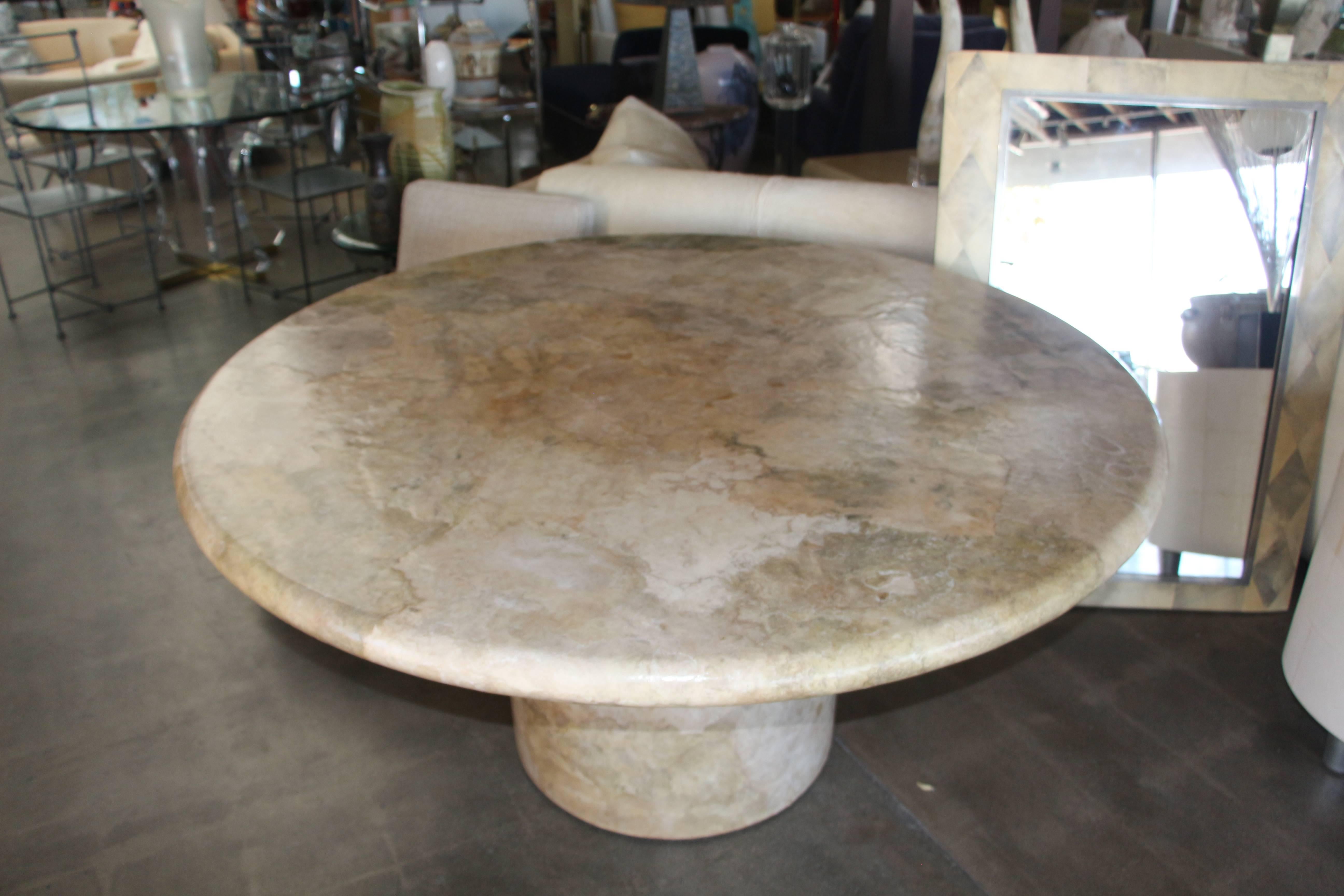 A round paper or parchment layered dining table designed by Steve Chase. An unusual design. In good condition with minor wear and imperfections.