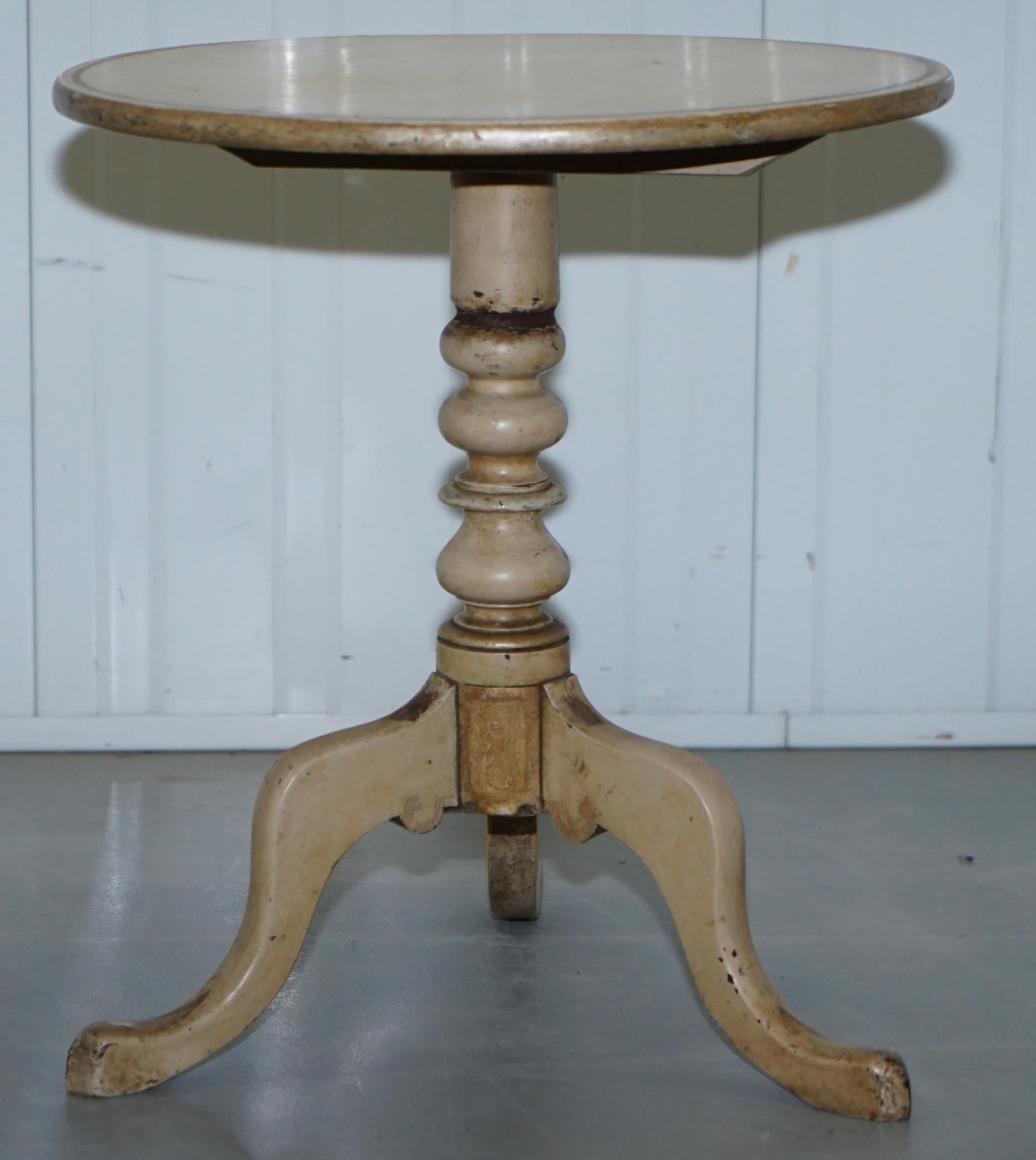 We are delighted to offer for sale this original Victorian tripod table with early period distressed paintwork 

This table is a Victorian tilt top side lamp wine tripod table, it was overpainted with this chalky creamy white paint decades ago and