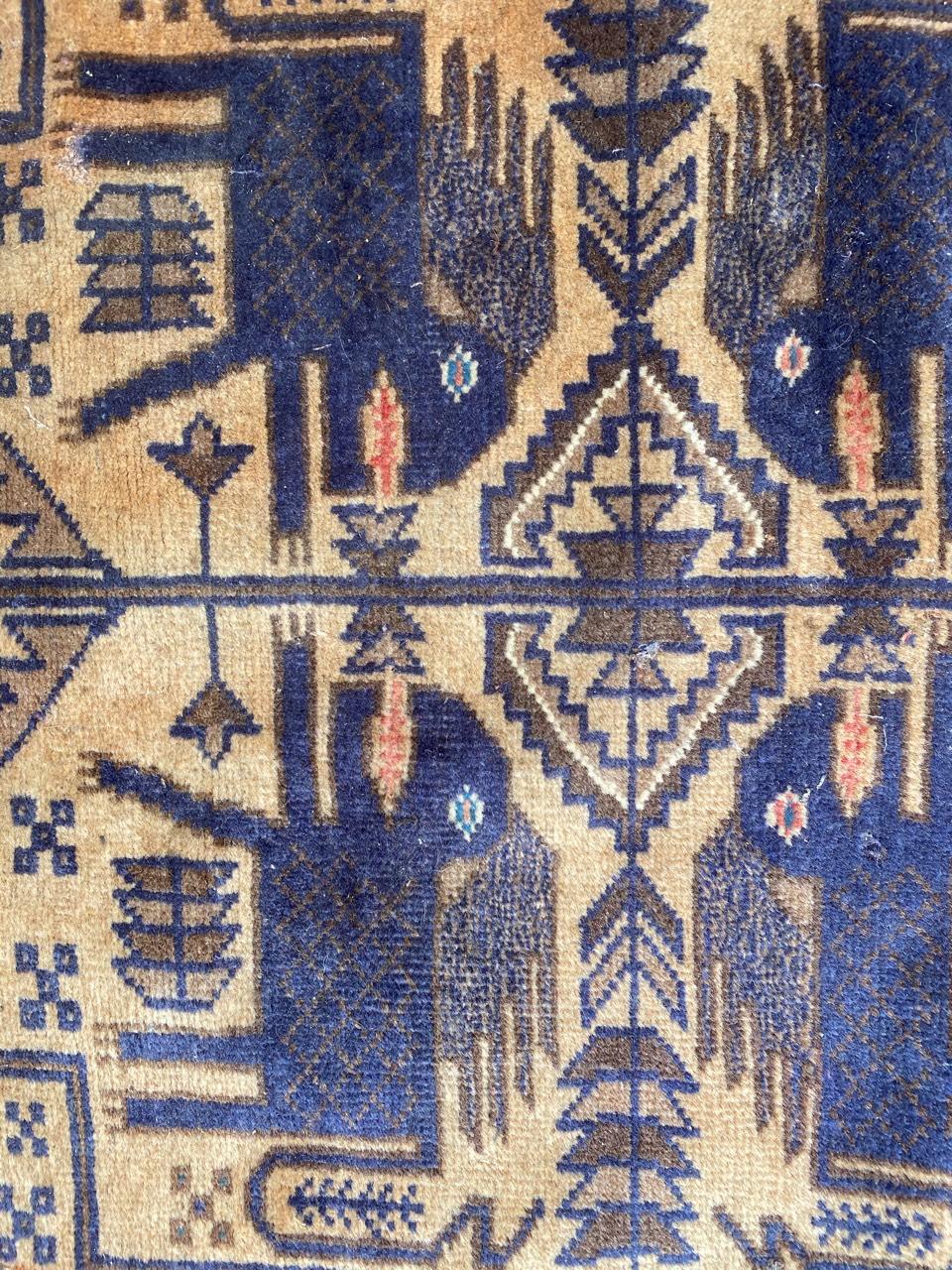 Beautiful vintage Afghan Belutch rug with a tribal design and blue, green and yellow colors, entirely hand knotted with wool velvet on wool foundation.