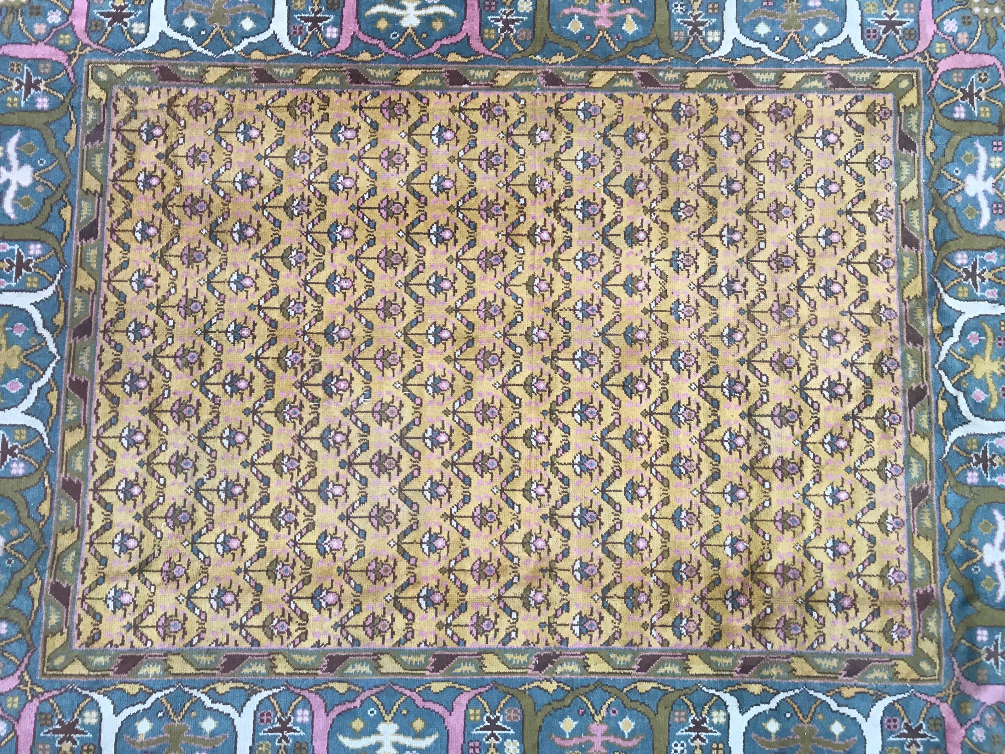 Beautiful Spanish hand knotted rug with a decorative design and a yellow field color with blue, green and pink, entirely hand knotted with wool velvet on cotton foundation.