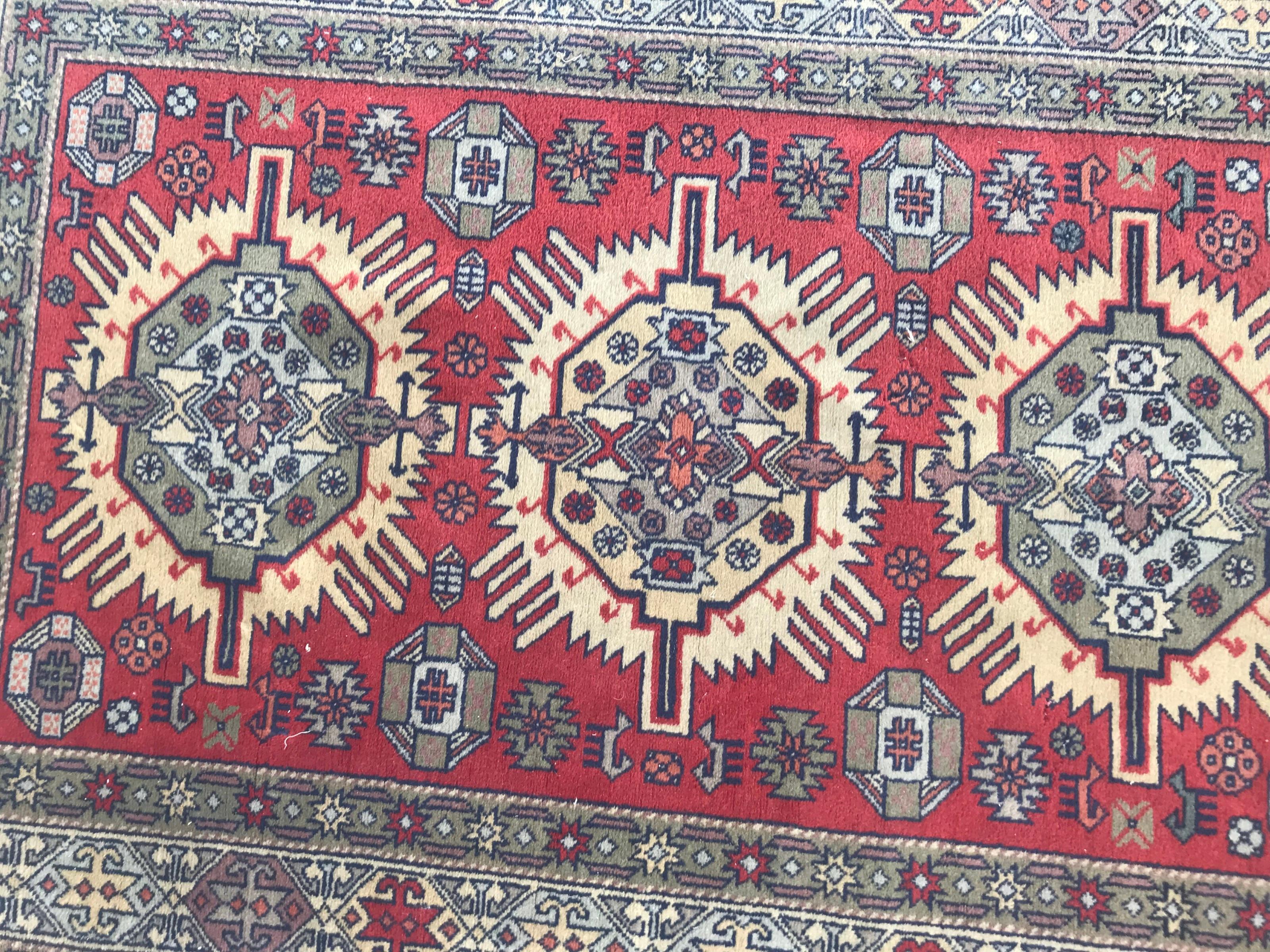 Beautiful 20th century Shirvan rug with a geometrical design and red, yellow and green colors, entirely hand knotted with wool velvet on cotton foundation.