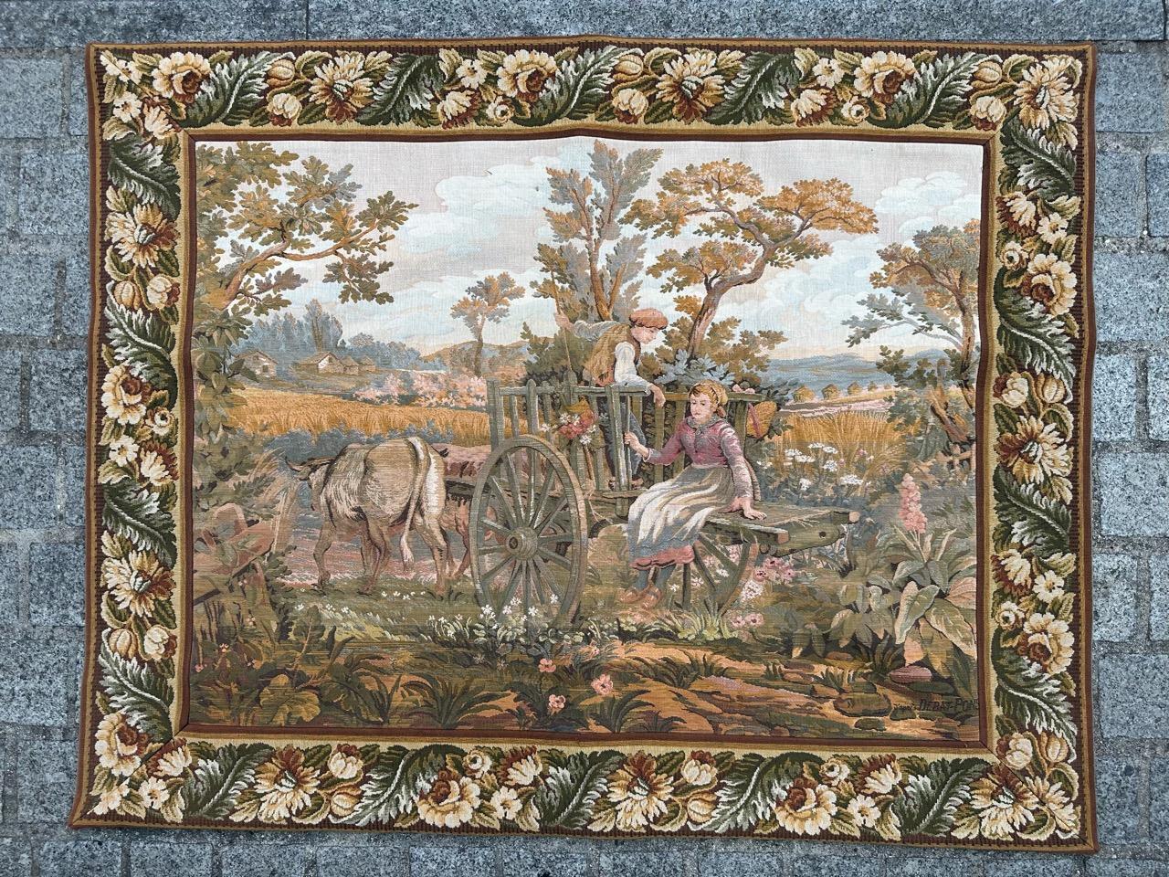 Exquisite 20th-century French tapestry featuring a charming gallant romantic design depicting a couple on a cart amidst a picturesque countryside scene. This stunning piece boasts vibrant colors and was meticulously woven using a Jaquar mechanical
