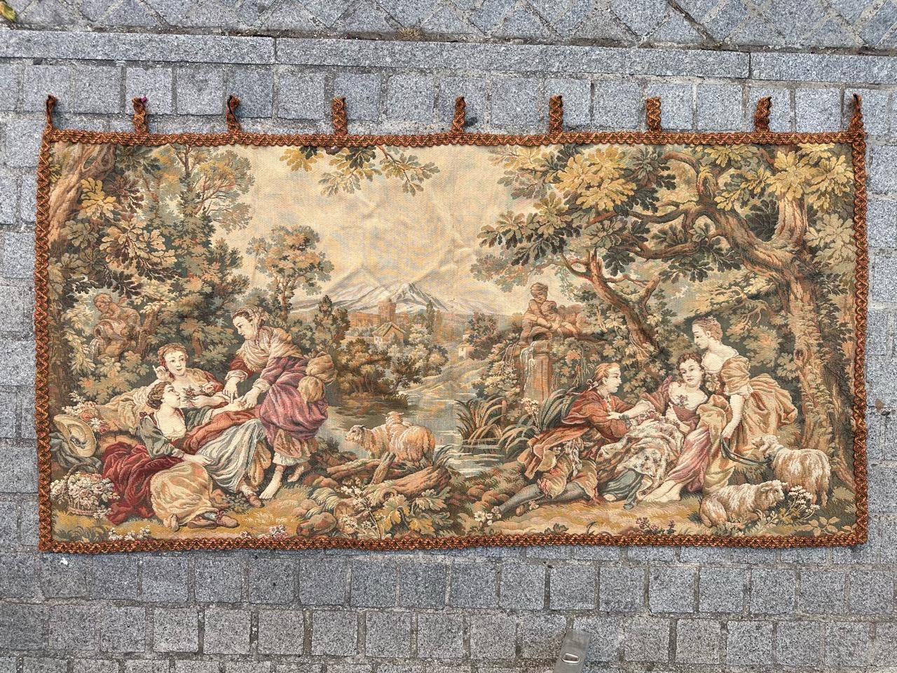 Discover this exquisite mid-century French tapestry, adorned with a stunning gallant design and a vibrant array of colors. Meticulously woven by mechanical Jaquar manufacturing using a blend of high-quality wool and cotton.

The tapestry's