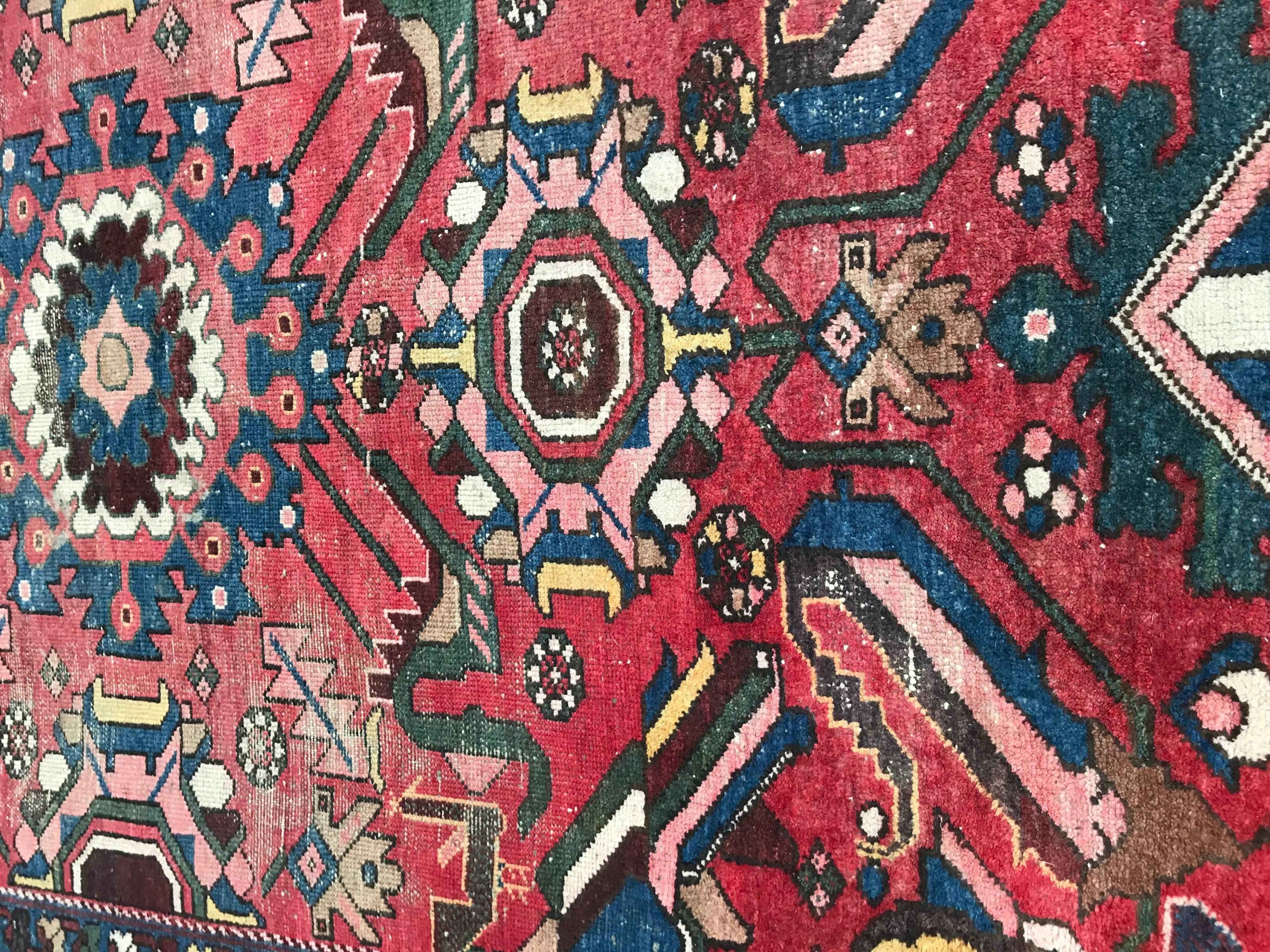 Beautiful mid-20th century rug with tribal design and nice colors with red, blue, yellow and green, entirely hand knotted with wool velvet on cotton foundation.