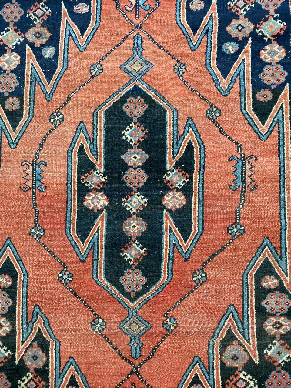Beautiful midcentury rug with a nice tribal and geometrical design, with nice colors with a red orange, blue and little green, entirely hand knotted with wool velvet on cotton foundation.