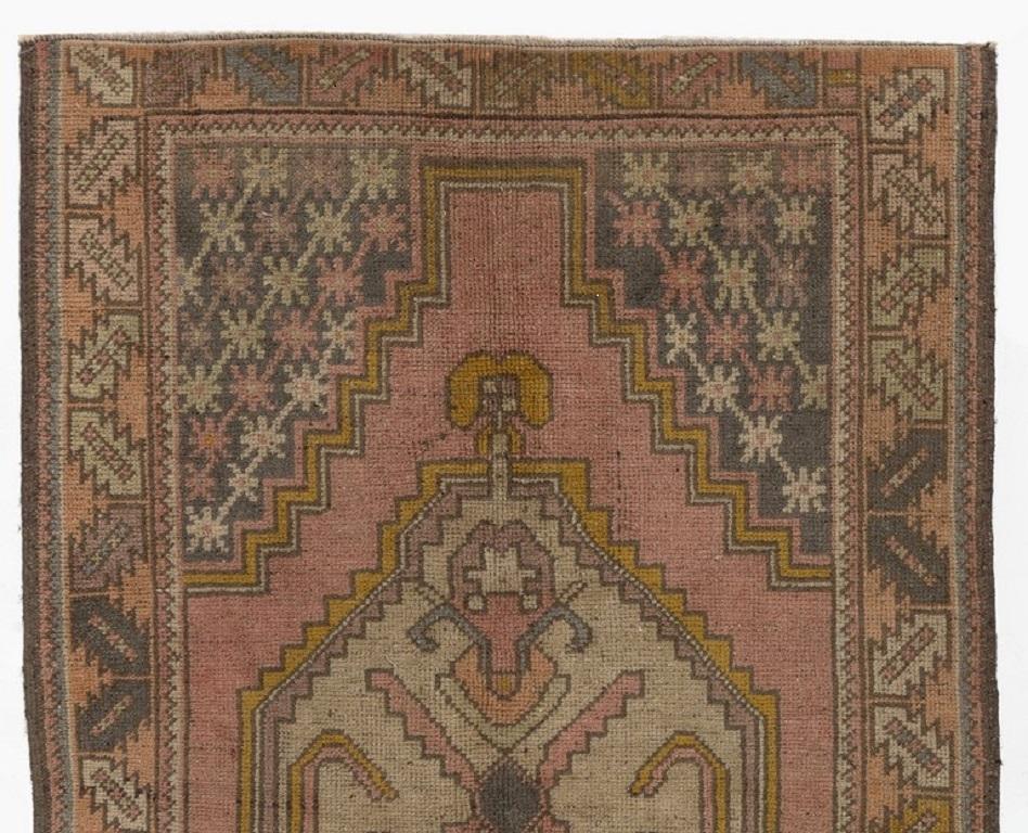 A vintage Turkish rug from 1950s featuring a geometric medallion design. The rug has even low wool pile on wool foundation, lays flat on the floor, in very good condition with no issues. It has been washed professionally, 
The rug is sturdy and can