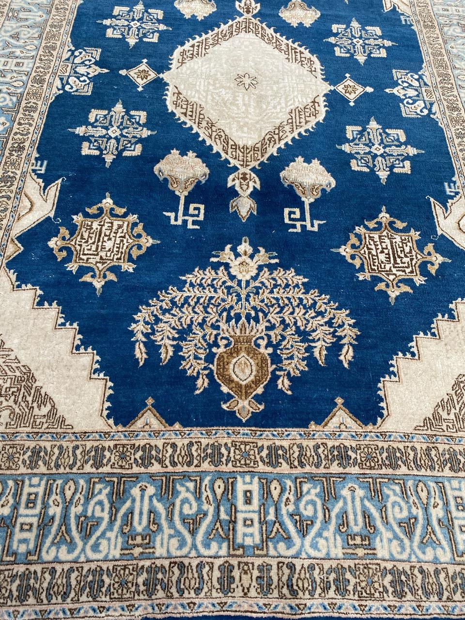Very beautiful mid century Qom rug with nice floral design and beautiful colors with a blue field, entirely hand knotted with wool and silk velvet on cotton foundation.