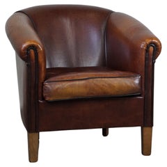 Nice vintage sheep leather club chair with black piping, luxurious English look