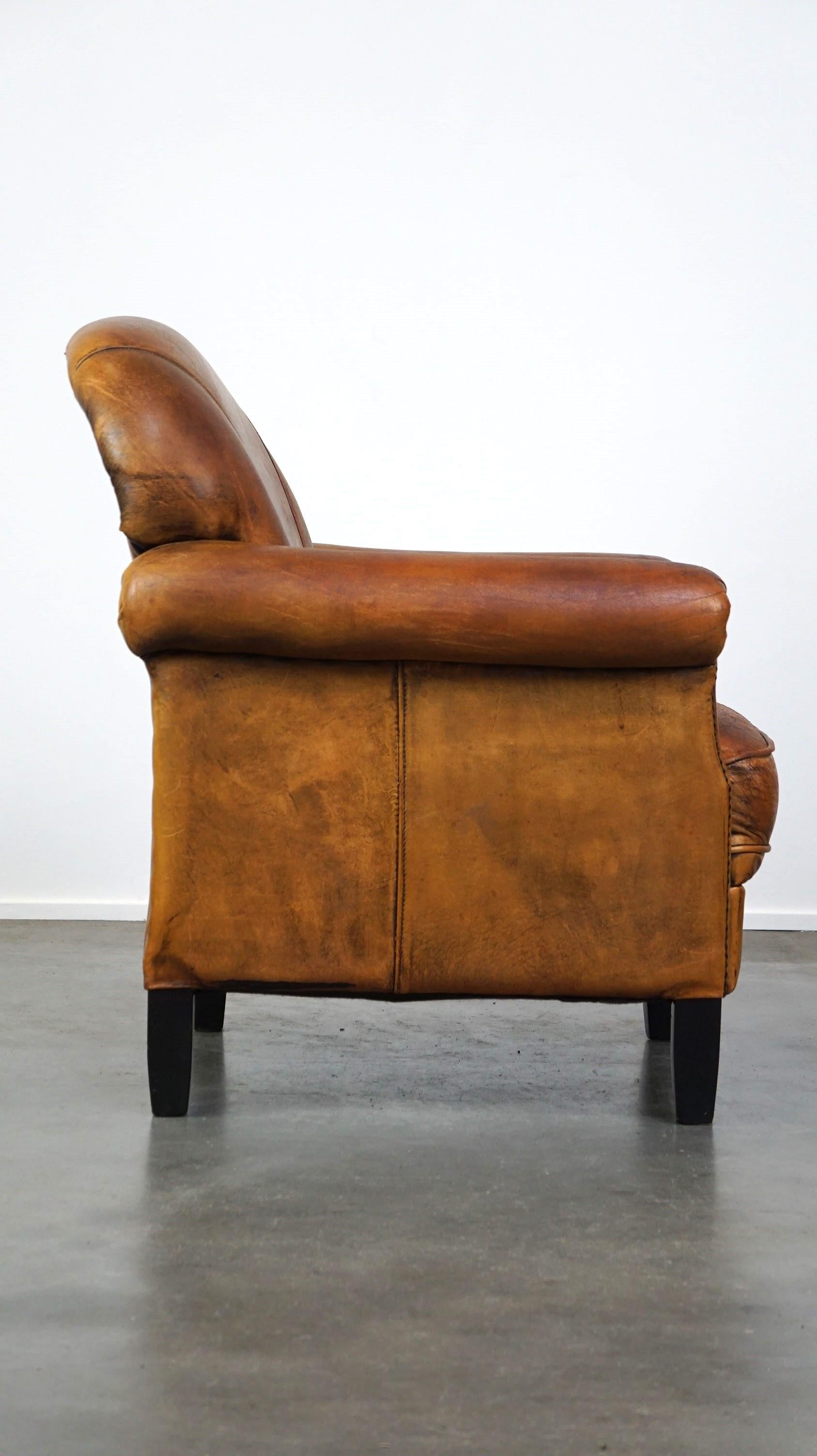 Nice vintage sheepskin armchair with beautiful colors and a comfortable seat In Fair Condition For Sale In Harderwijk, NL