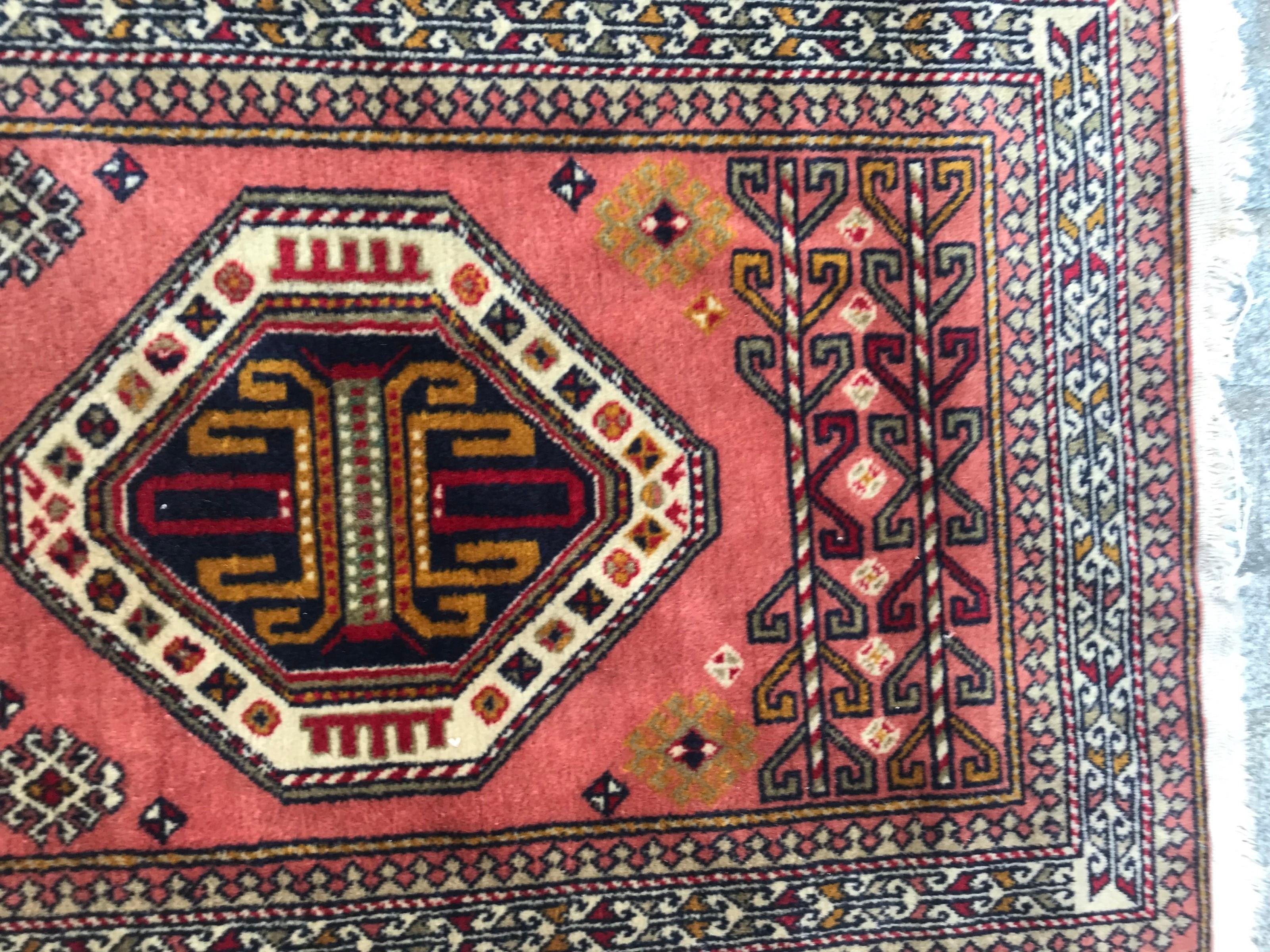 Beautiful late 20th century runner with a geometrical design of Caucasian rugs and nice colors with pink, green, yellow and blue, entirely hand knotted with wool velvet on cotton foundation.
