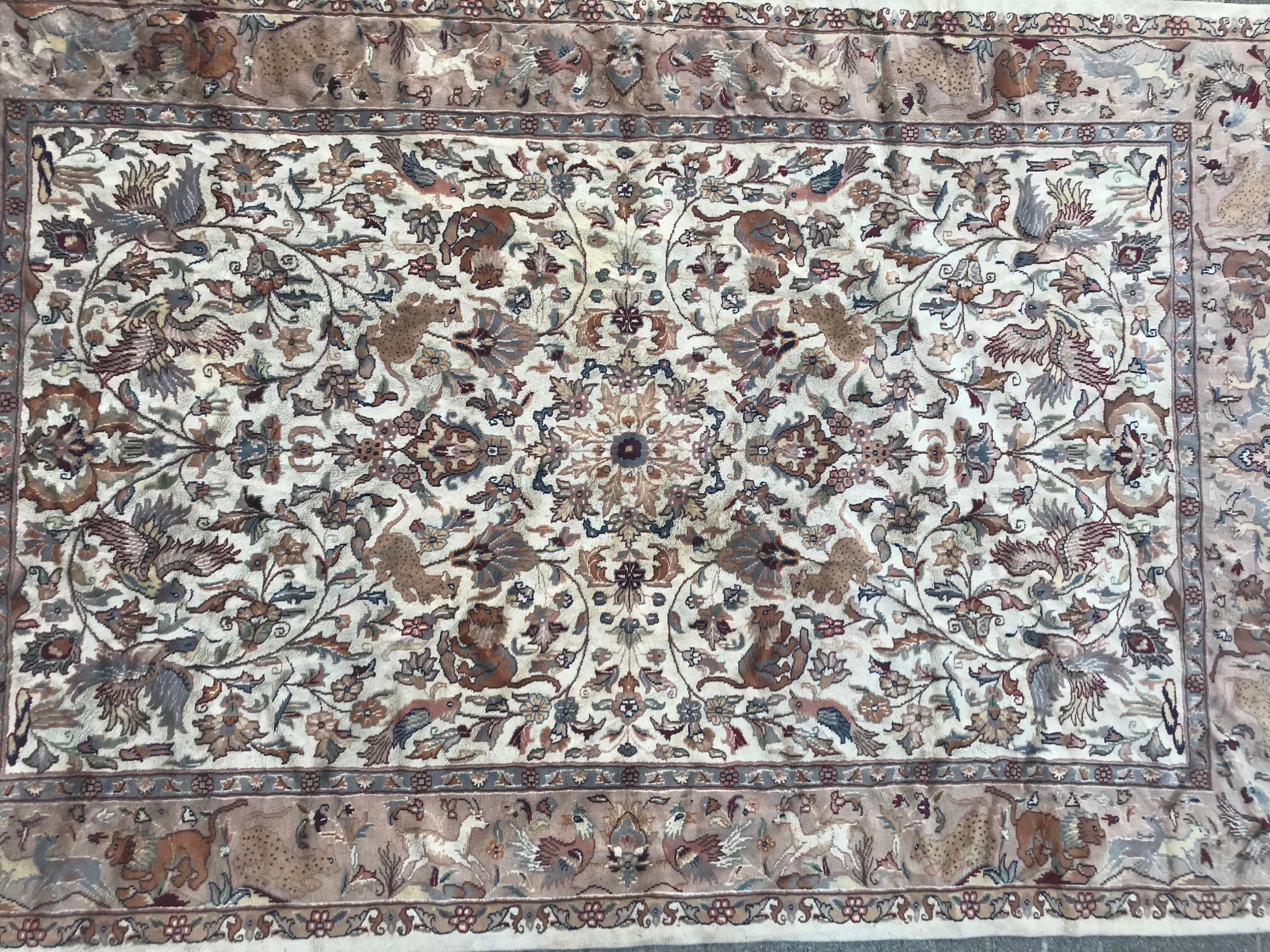 Beautiful late 20th century Pakistani rug with animal design and light colors with pink, green, yellow and purple, entirely and finely hand knotted with wool and silk velvet on cotton foundation.