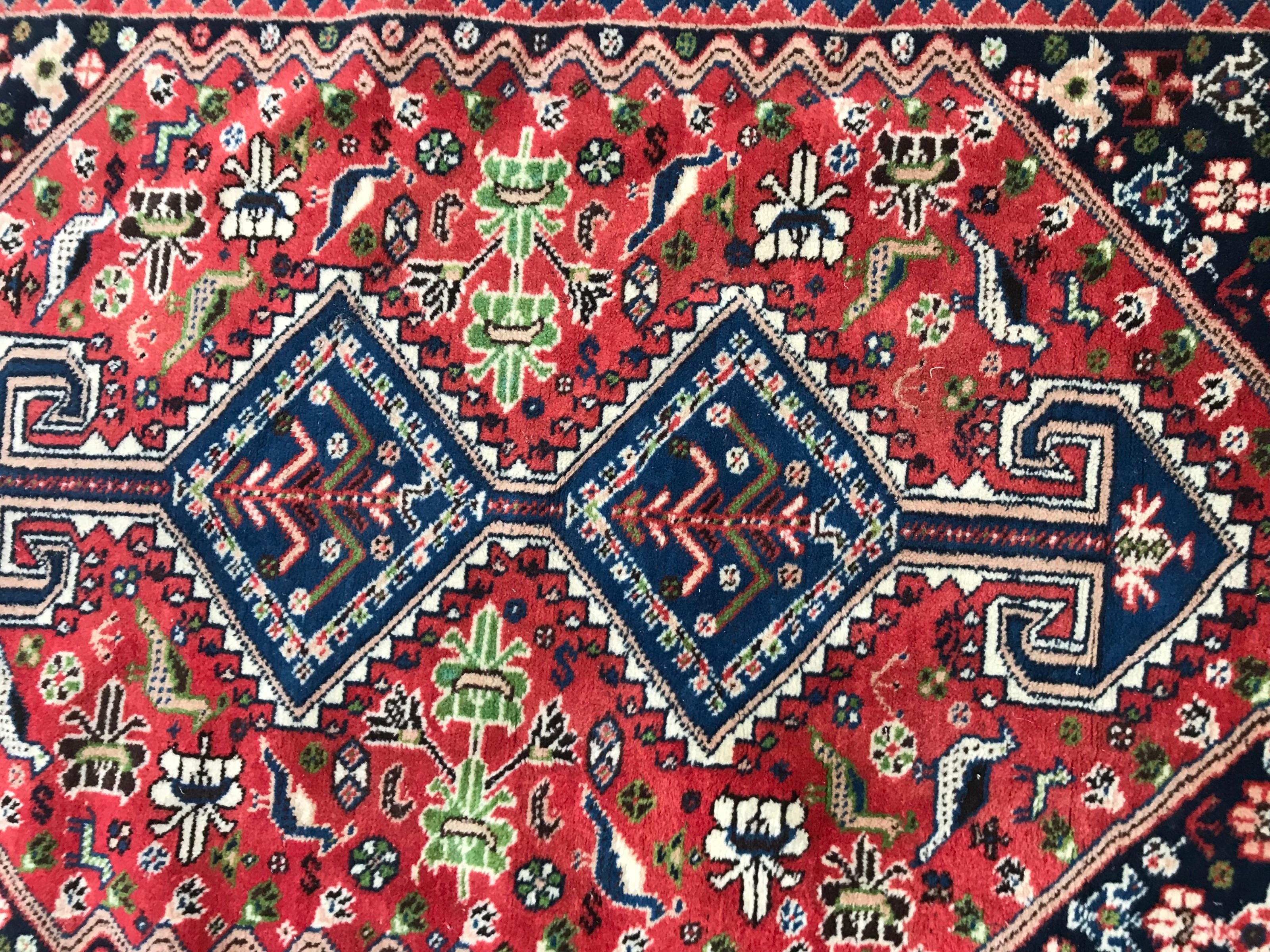 Beautiful late 20th century rug with nice geometrical tribal design, and beautiful colors with blue, red, green and brown, entirely hand knotted with wool velvet on wool foundation.