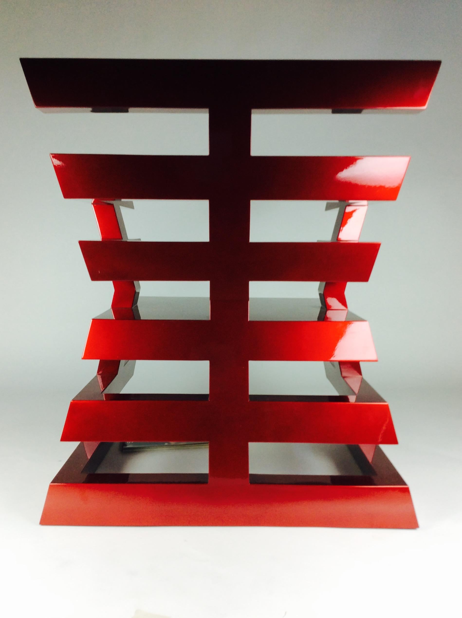 Re-editioned in a fierce powder coated red Chinese lacquer. This is the 25th anniversary edition of Nicholas Alvis Vega's Aztec chair.