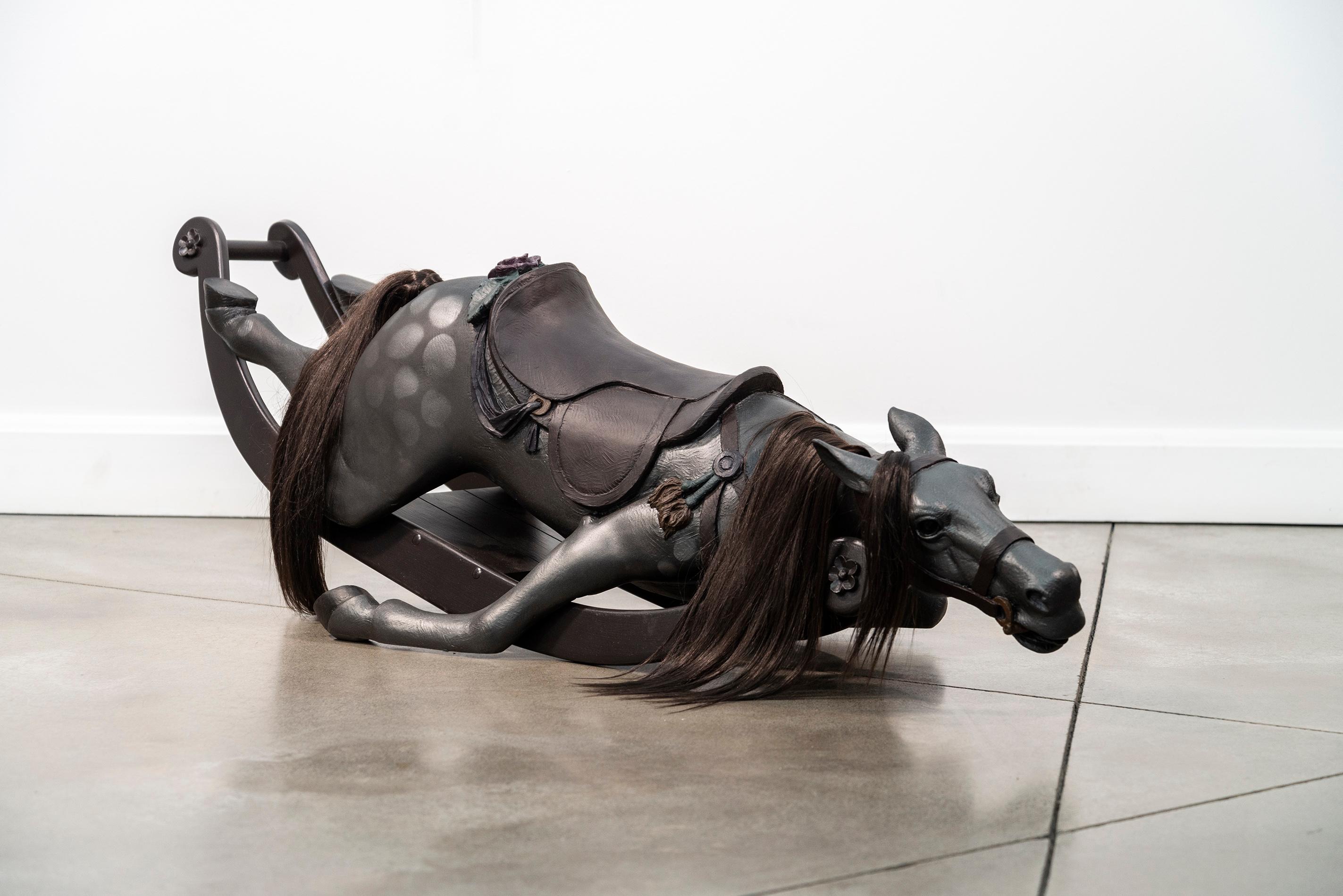It is a powerful image—at once compelling and provocative—an old-fashioned rocking horse, collapsed. This is the work of Nicholas Crombach.

The Kingston based artist creates sculptures from a variety of cast mediums including bronze and resin. This
