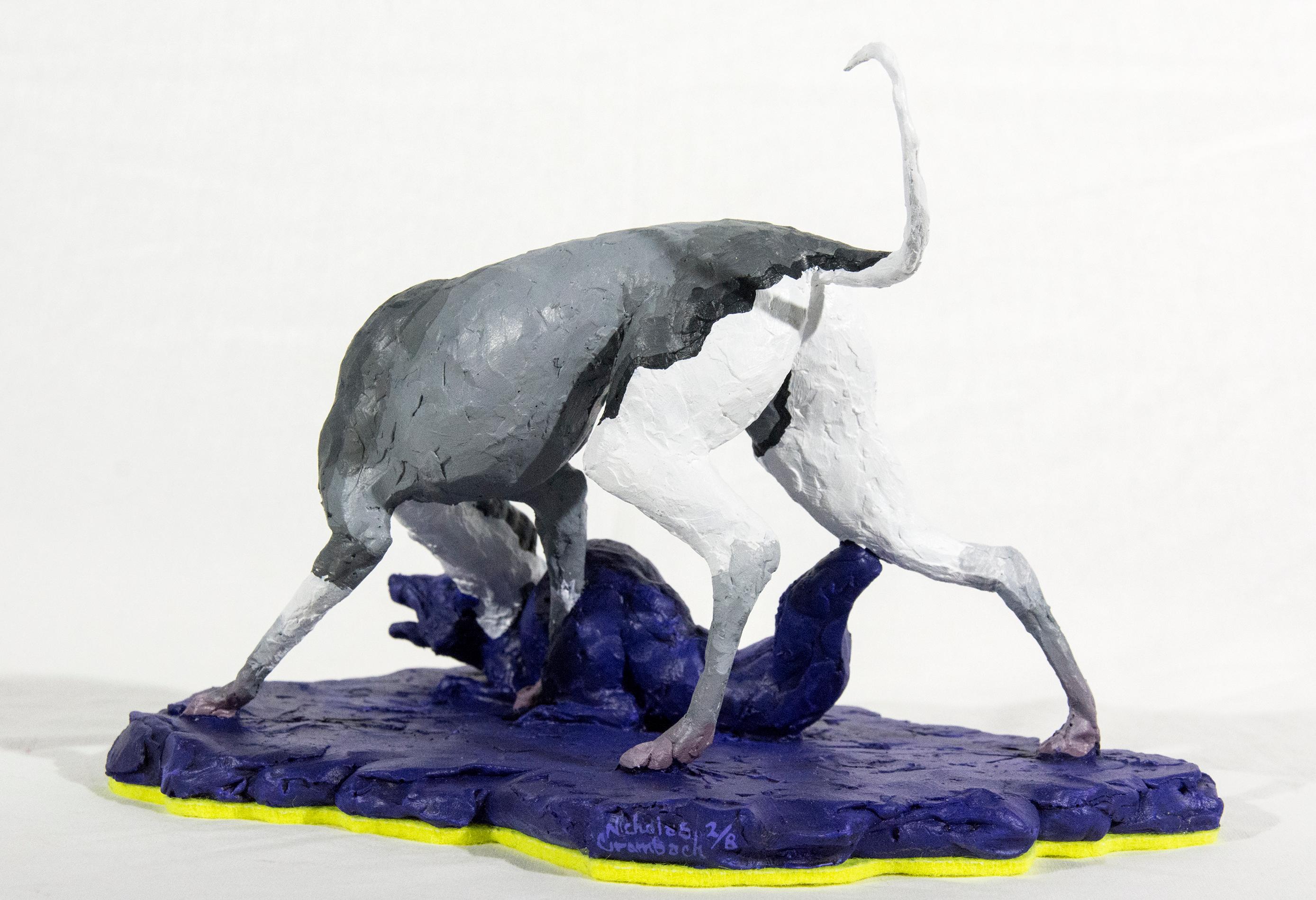 A cast resin figurine of a hound who has hunted a fox, which in turn has hunted a goose is patinated in indigo, black and white by emerging sculptor Nicholas Crombach.  The work reflects the artist's themes of human-animals relationships,