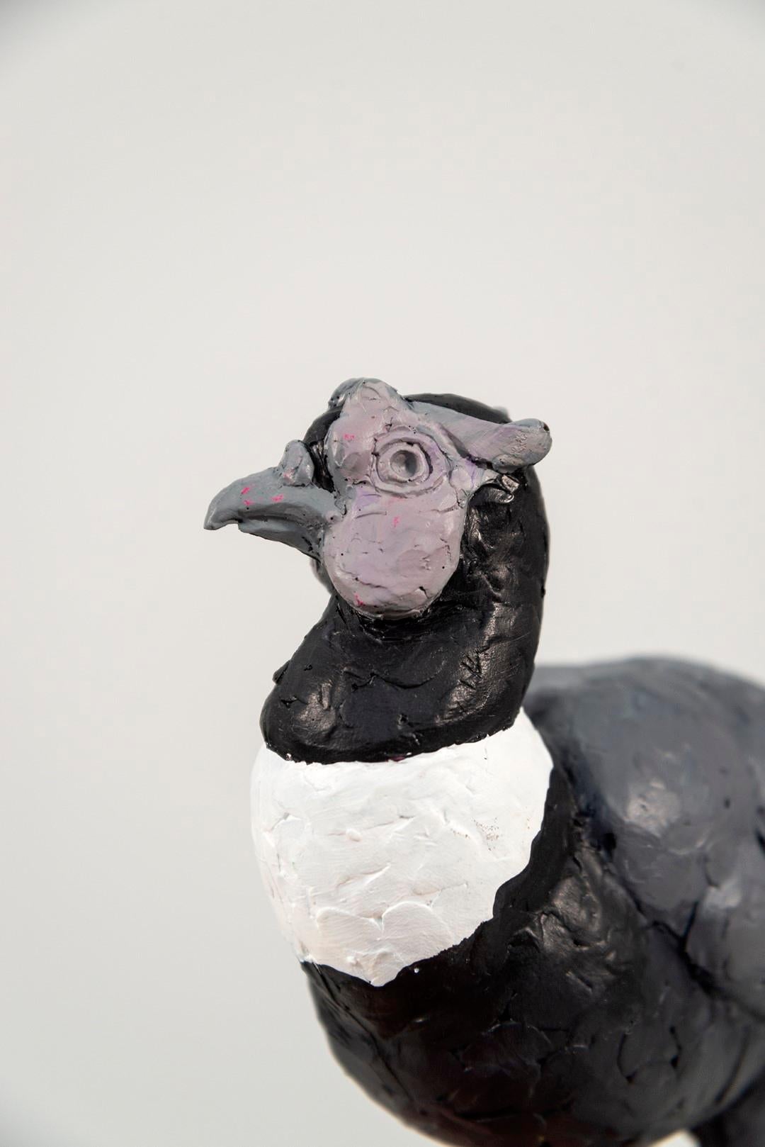 This tabletop indoor figurative sculpture of a bird is made of resin.
 
The provocative award-winning sculptures of Nicholas Crombach explore a narrative that challenges the complex dynamic of human and animal relationships. This figurine cast in