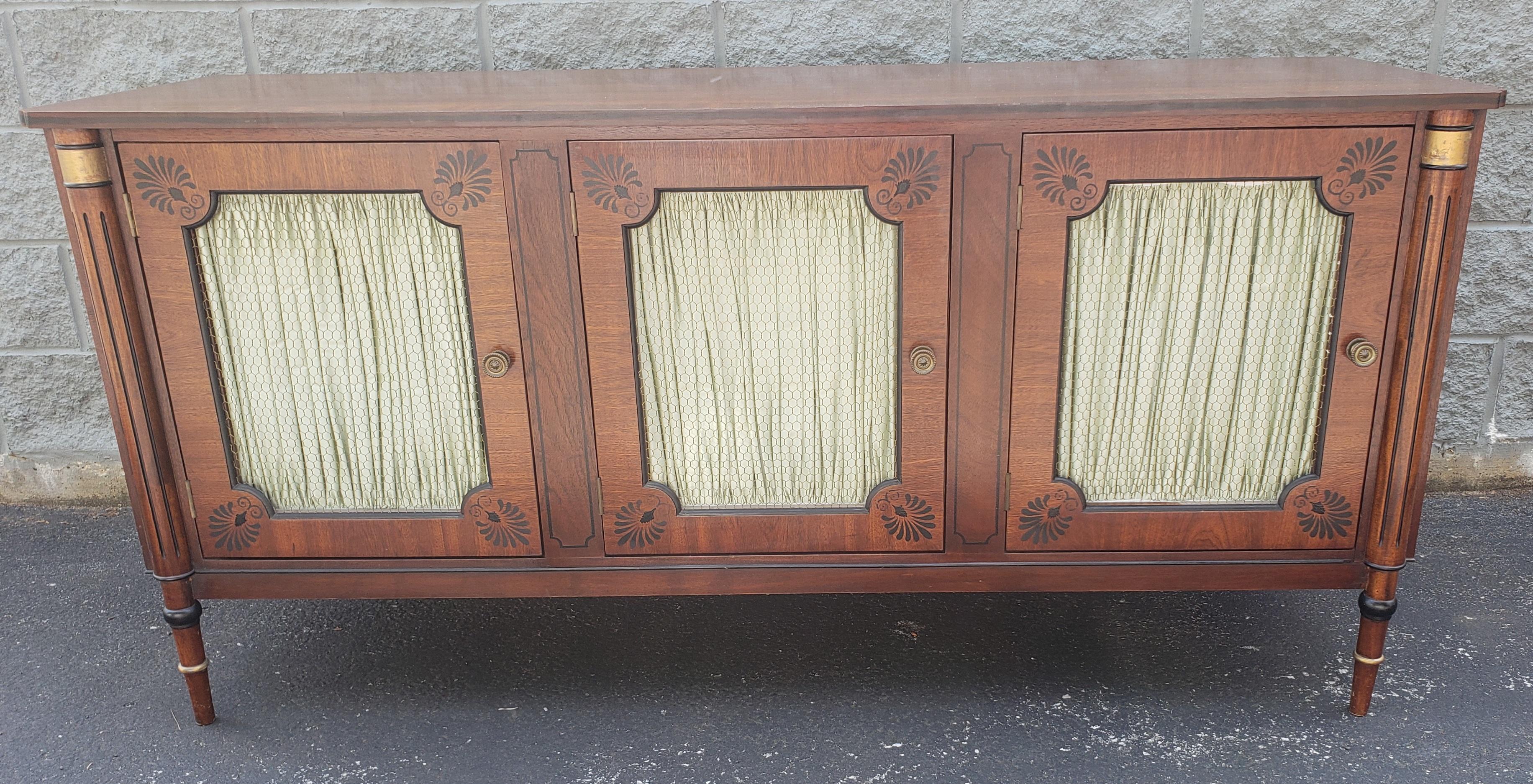 A custom Nicholas James Mid-Century English neoclassical Walnut Side board / Buffet / credenza with Curtains and wire Mesh Doors in good vintage condition.Features three large compartments that open to reveal three drawers fully felt lined to