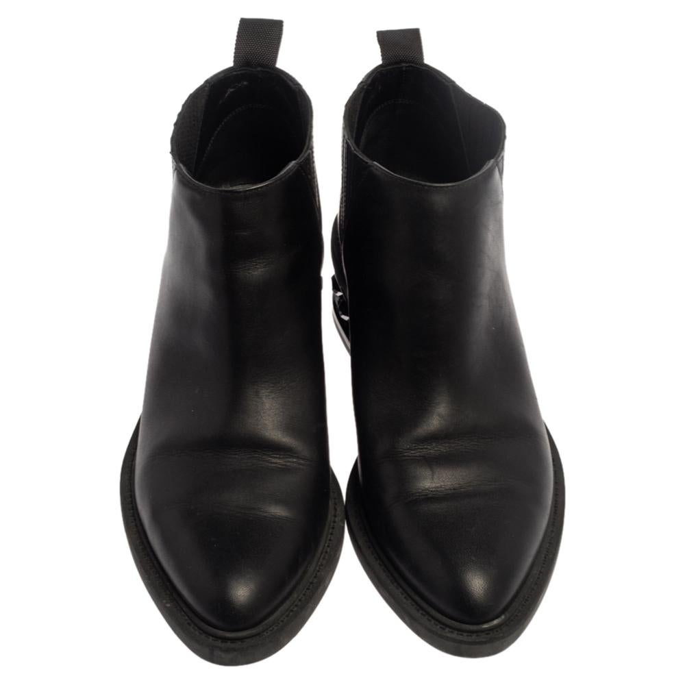 Enjoy the most fashionable days with these stylish ankle boots from Nicholas Kirkwood. Modern in design and craftsmanship, they are fashioned in black leather and designed with elastic inserts, pull tabs, and studs on the low heels.

