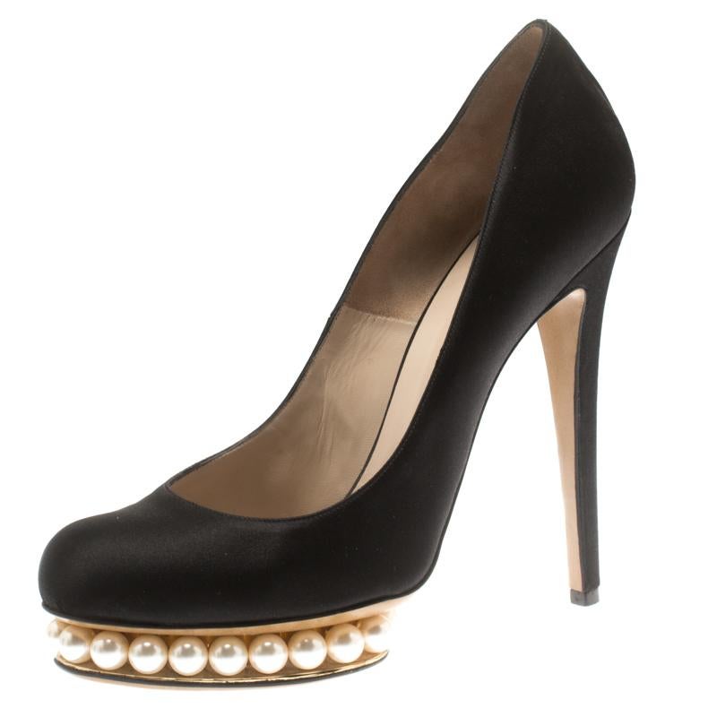 Step out in sophisticated style with these Casati platform pumps from the luxury fashion house of Nicholas Kirkwood. They are crafted from satin and feature a classic black hue. They come with faux pearls inlaid in the platforms, leather soles, and