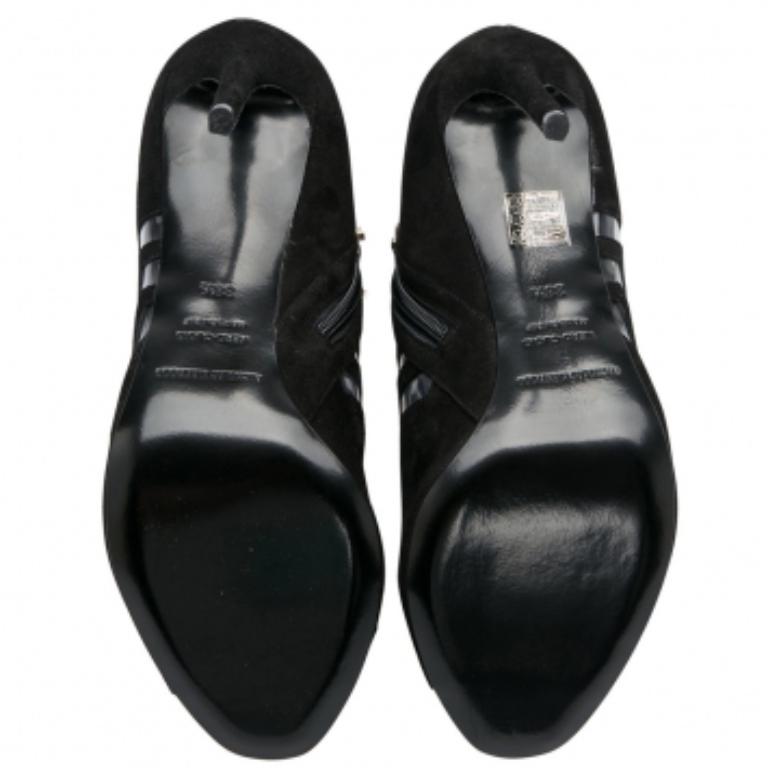 Crafted from black suede and detailed with PVC in a chevron pattern, these peep-toe booties from Nicholas Kirkwood have been purposely built to lift your style. They are complete with side zippers and 11 cm heels.