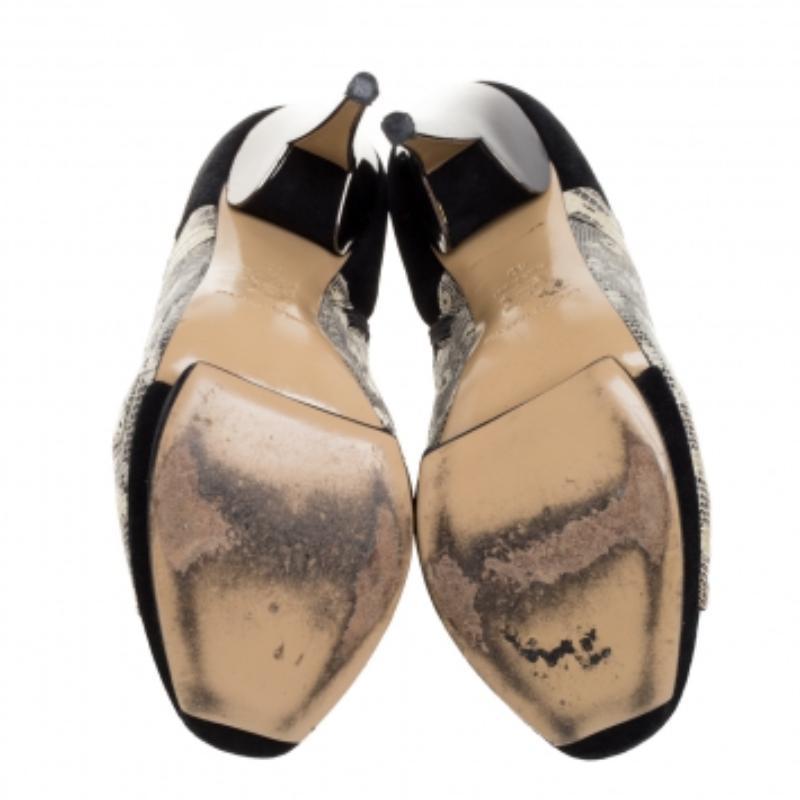 How can one not fall in love with these gorgeous booties from Nicholas Kirkwood! Crafted from lizard skin and suede, these booties feature a peep-toe silhouette and side zippers. They are elevated on solid platforms and 14 cm heels and made