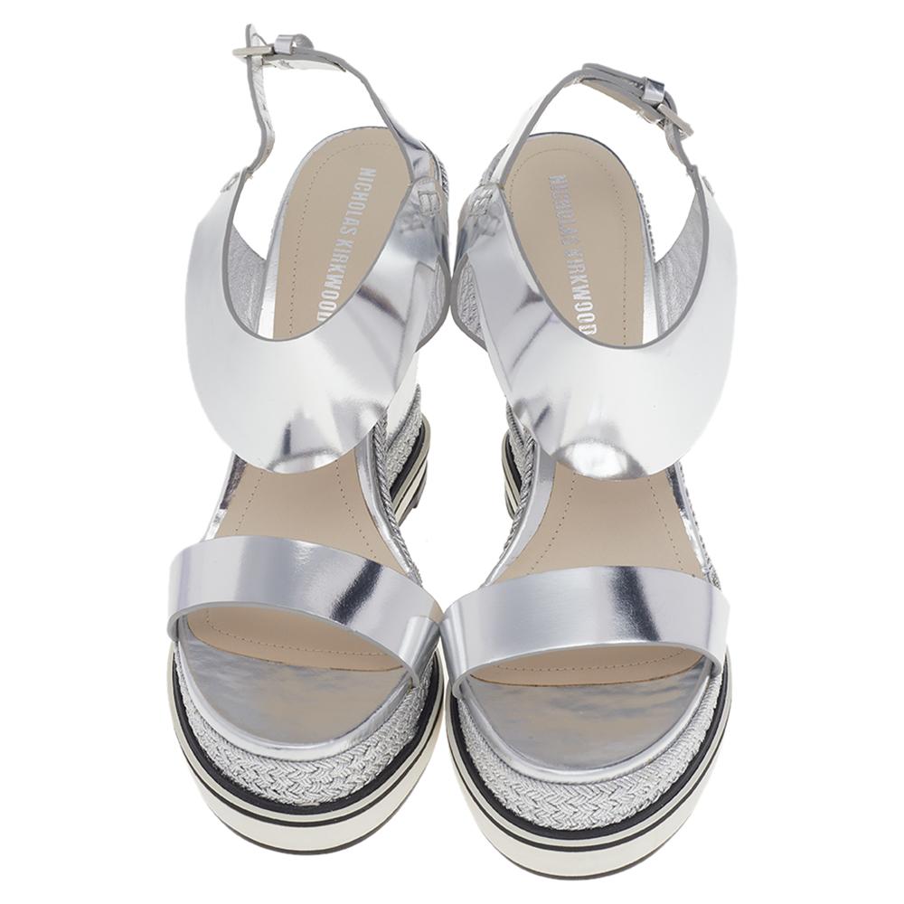 Complete a summer look with this pair of Nicholas Kirkwood sandals. Constructed using foil leather, the open-toe sandals are secured with buckle closure at the ankles, lined with leather on the insoles, and lifted on wedge heels and espadrille