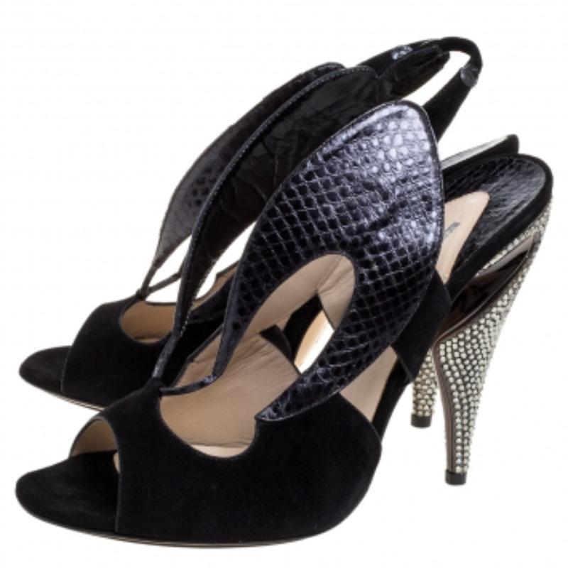 Simple, sophisticated, and stylish, these Nicholas Kirkwood sandals are crafted from black suede and python-embossed leather and feature open toes. They have been styled with cut-out details, slingbacks, and 12.5 cm heels. These beauties are