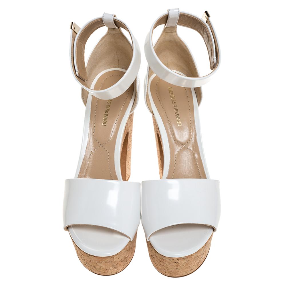 These Maya sandals from Nicholas Kirkwood will not only make you shine but will also fetch you a lot of admiring glances. The white sandals are crafted from leather and feature an open toe silhouette. They flaunt single vamp straps and come equipped