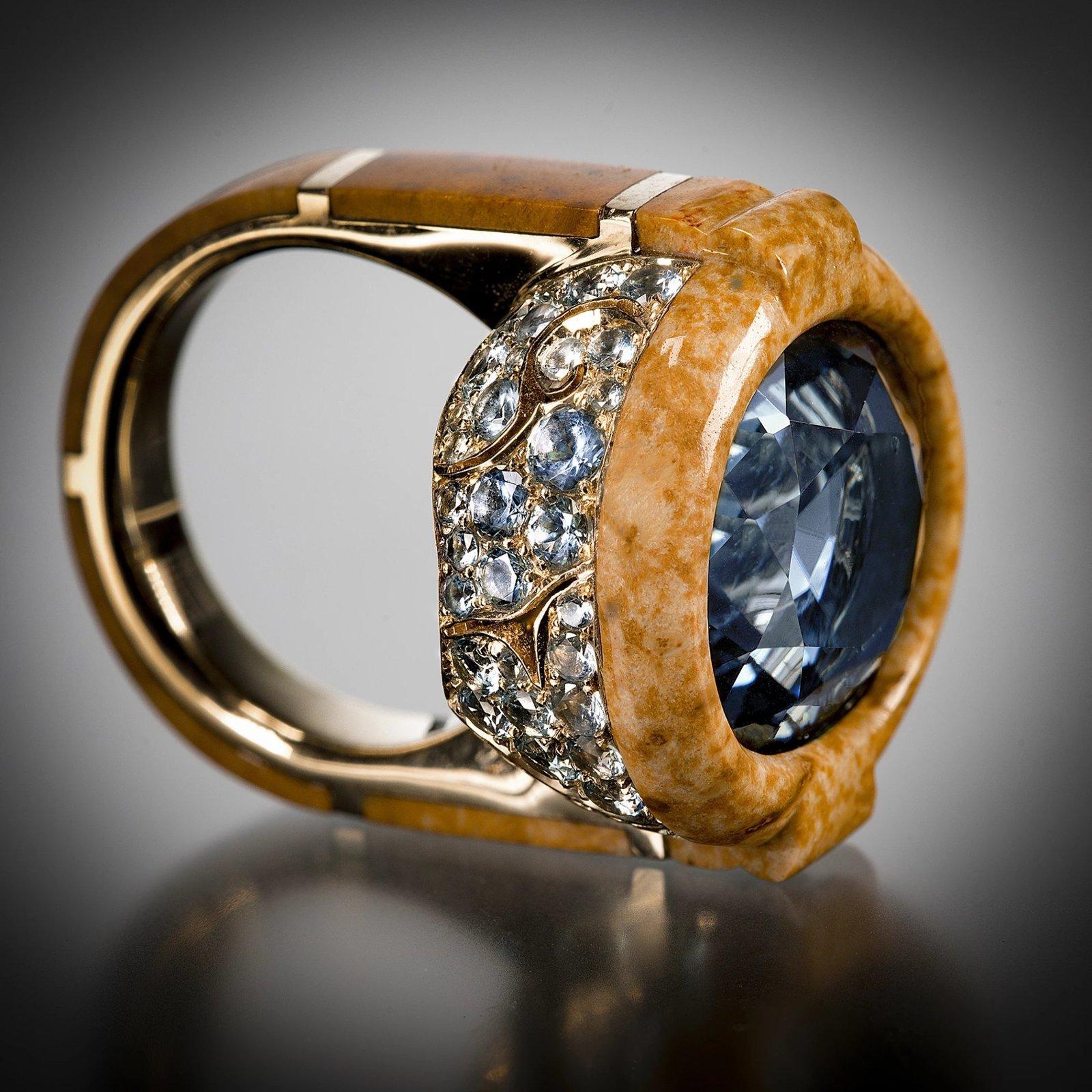 Varney’s Gion ring is named after Kyoto’s most famous Geisha district. It centers on a Sterling Blue tourmaline weighing approximately 4.6 carats, trimmed with petrified palm wood and set in a pierced gold “cloud motif” bowl that is pave set with