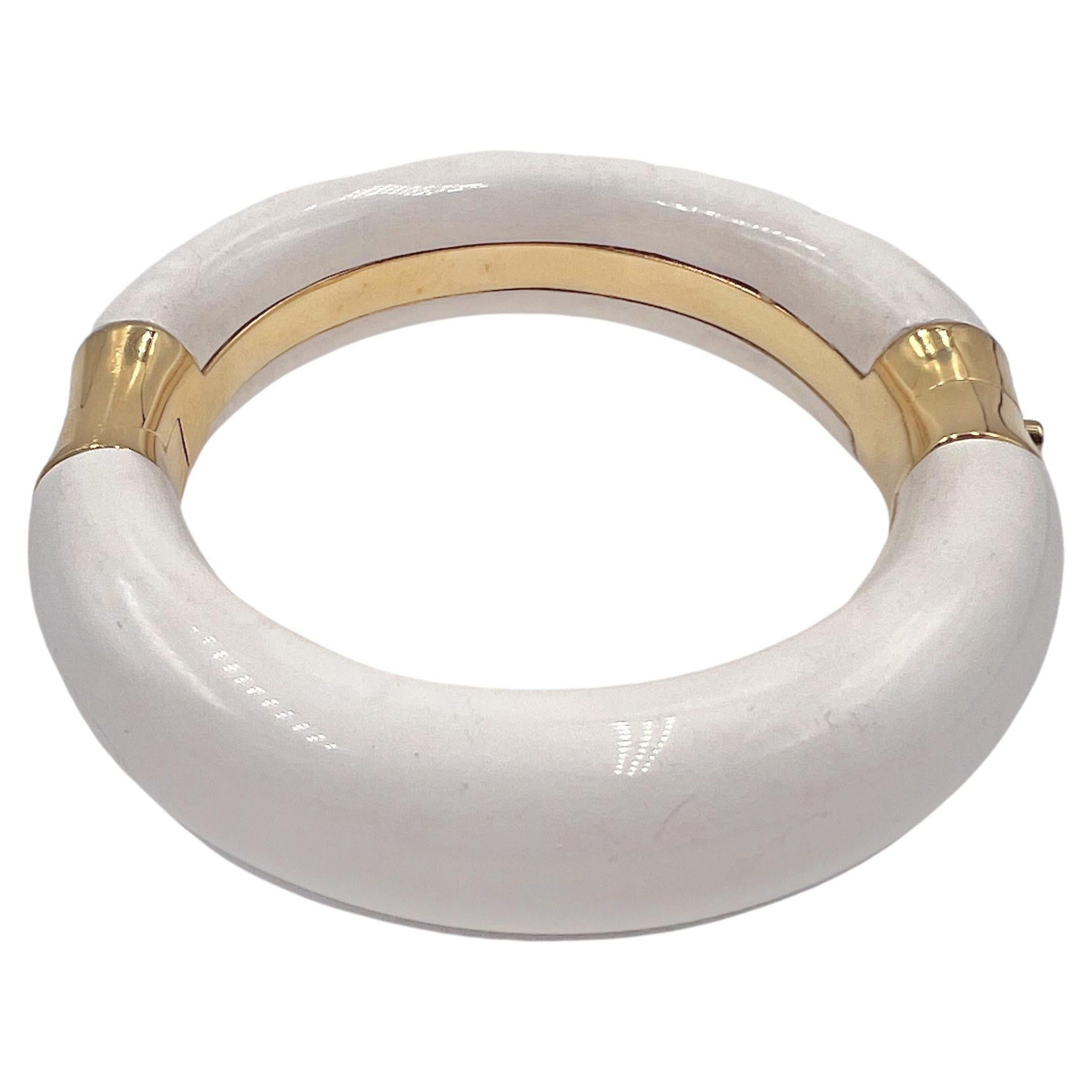 Cocholong 18k yellow gold hinged bangle bracelet by designer Nicholas Varney.  Polished cream-toned cocholong mounted on 18kt yellow gold with a hinge and bezel-set diamond push closure.  Measuring 17.70mm in width.  Interior diameter: 2.50