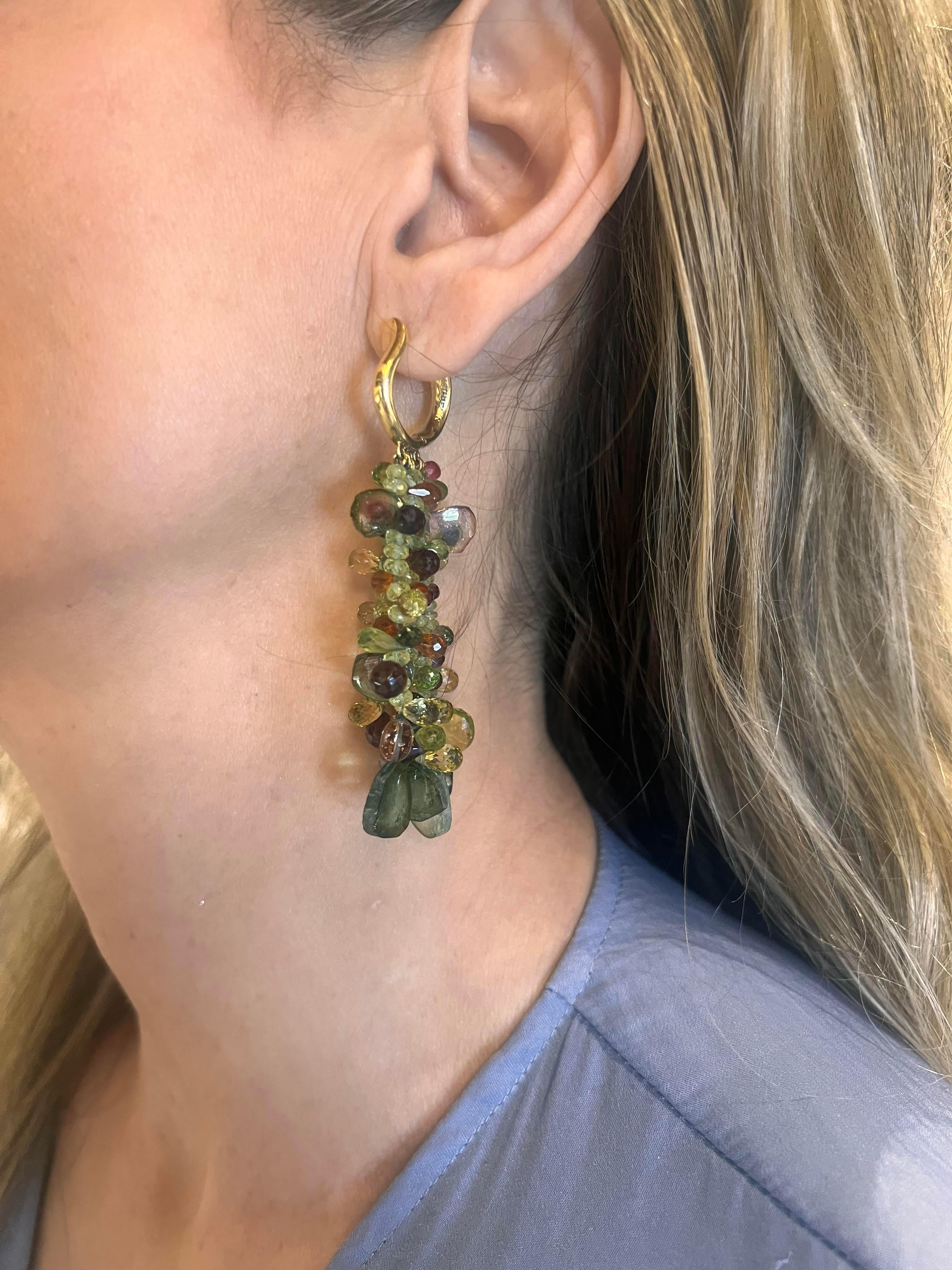 Nicholas Varney multicolored tourmaline bead drop earrings.  18k yellow gold polished 'U'-shaped hoops at top, each suspending five strands of various-shaped and colored tourmaline beads in green, red, pink, and pinkish-orange hues, some of them cut