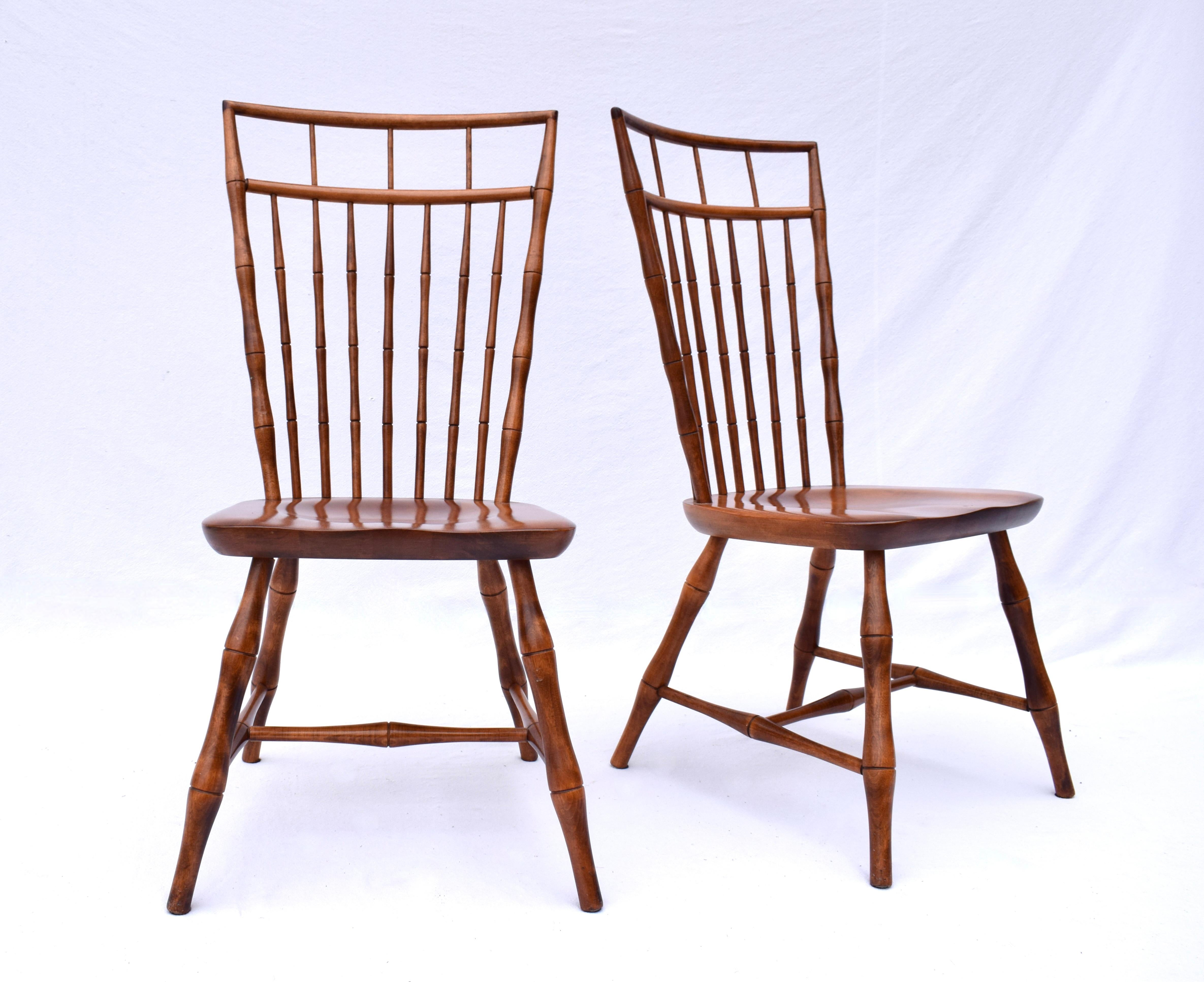 A pair of Nichols & Stone Birdcage Windsor dining chairs featuring split wedge mortise and tenon joinery with faux bamboo turned spindles, legs & H stretchers. No longer in production, Nichols & Stone was purchased in 2008 by Stickley Furniture.  A