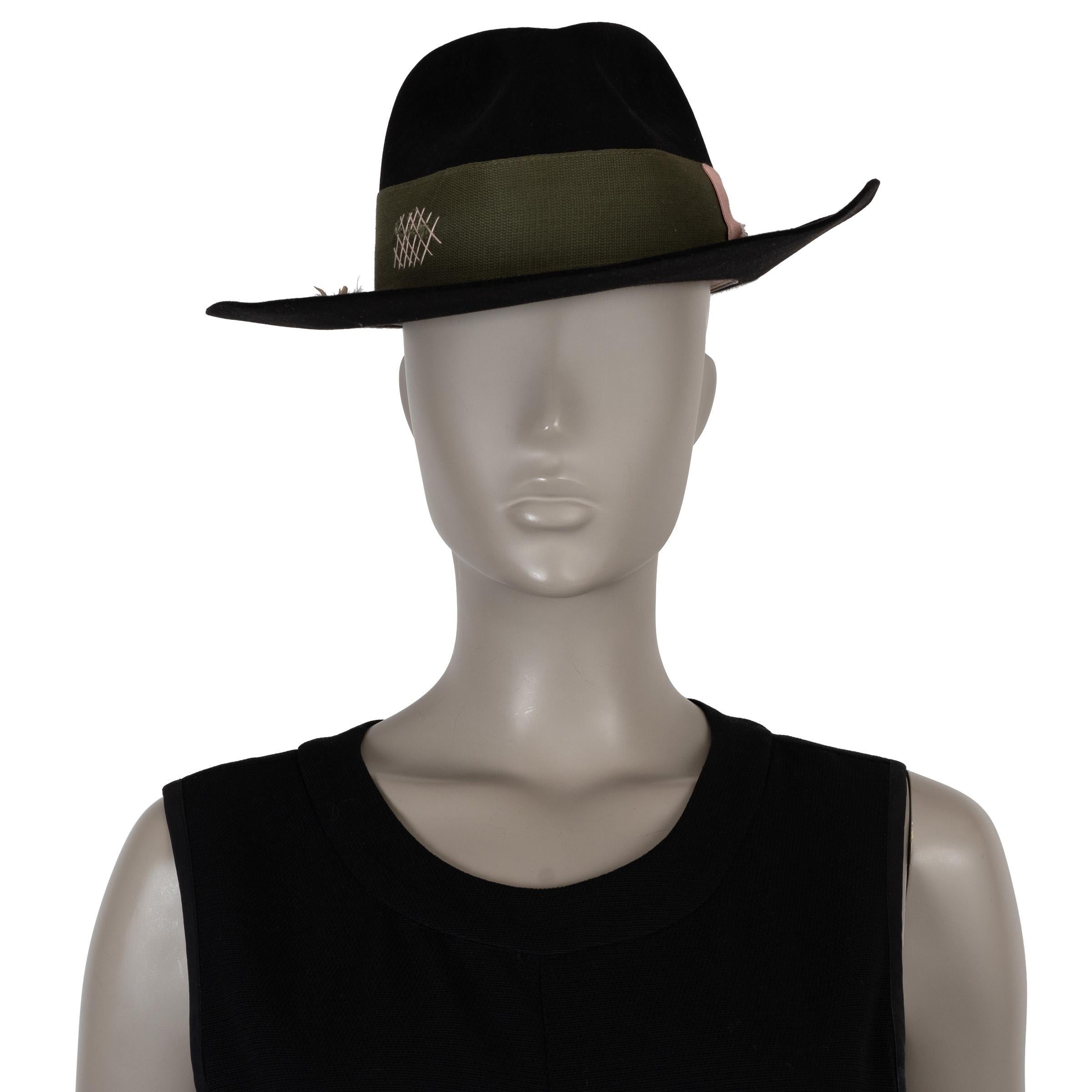 Questo cappello fedora Nick Fouquet Che, autentico al 100%, è realizzato in feltro di castoro nero (100%). Presenta una fascia in nastro di gros grain verde oliva con cuciture bianche, un fiocco rosa a contrasto e il dettaglio a fiammifero tipico