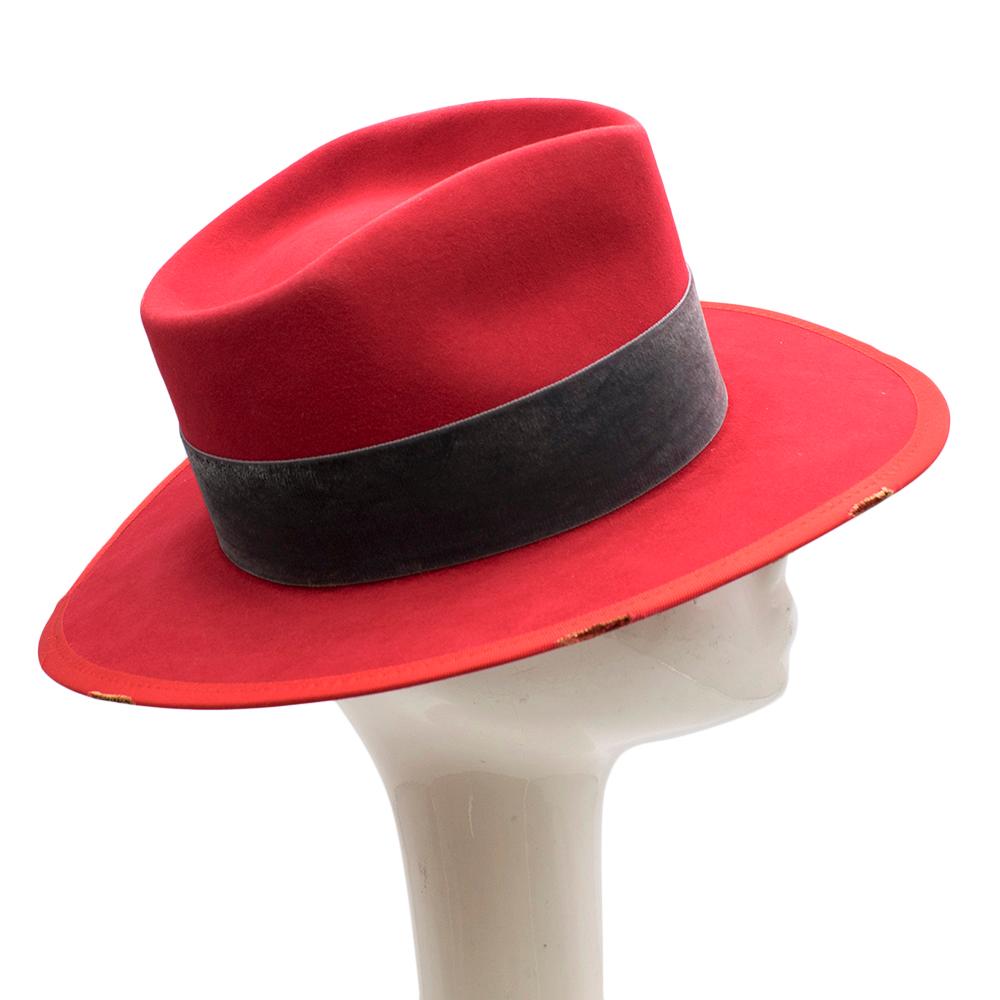 Nick Fouquet red wool hat featuring a stiff brim, a concave top, straight band, green bow detail and a signature matchstick

Please note, these items are pre-owned and may show signs of being stored even when unworn and unused. This is reflected