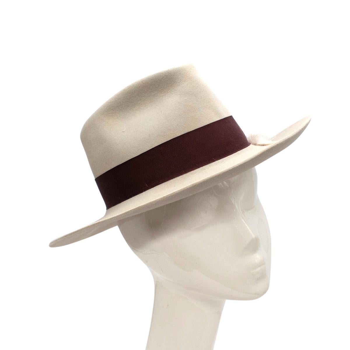 Nick Fouquet Stone Grey Felt Feather Detail Matchstick Fedora 

- Classic fedora crafted in felt in a stone grey colour
- Real feather tucked into the band
-Dark Brown grosgrain band with butterfly bow
- Signature matchstick to the band
- Lined in