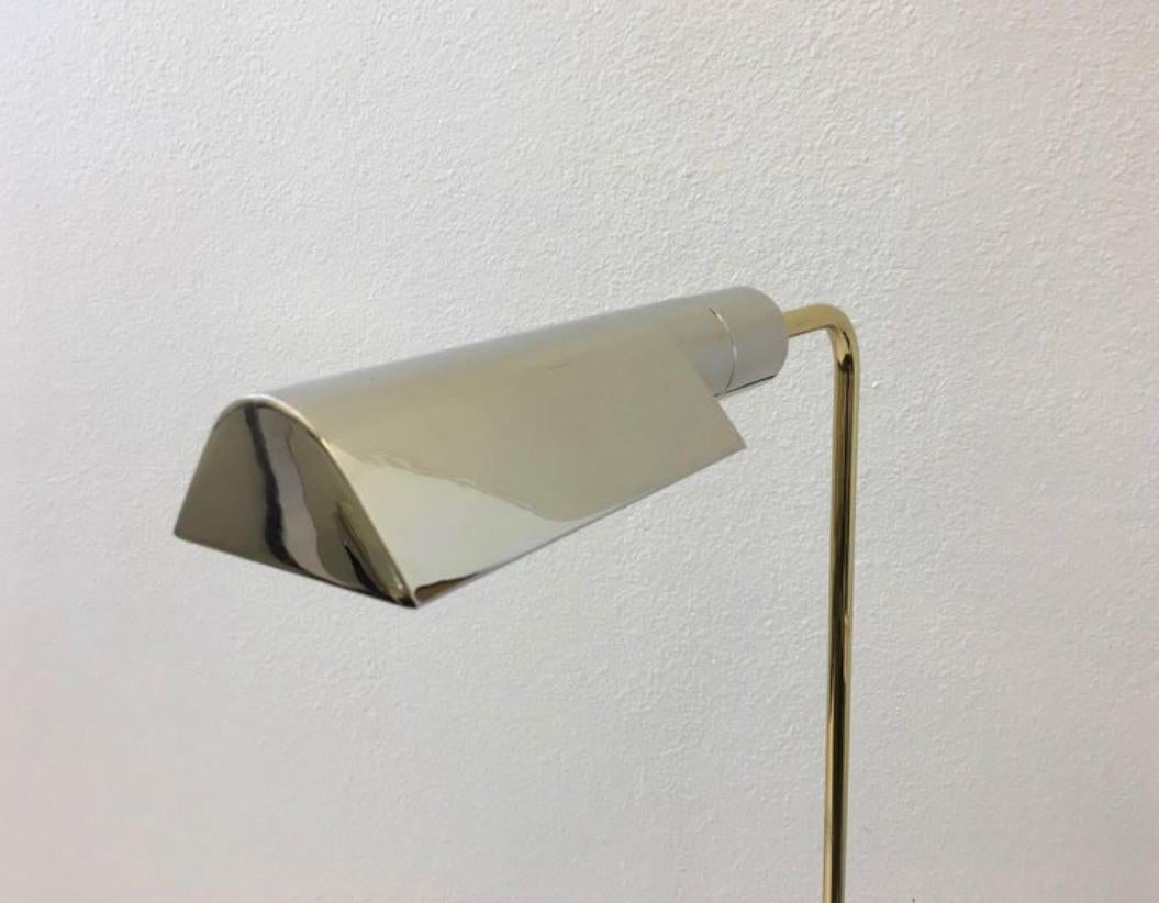 Two-tone adjustable floor lamp, designed by Casella lighting in the 1970s.
Newly replated, the base and shade are polished nickel, the adjustable pole is polished brass. The lamp has been newly rewired, with a full range dimmer