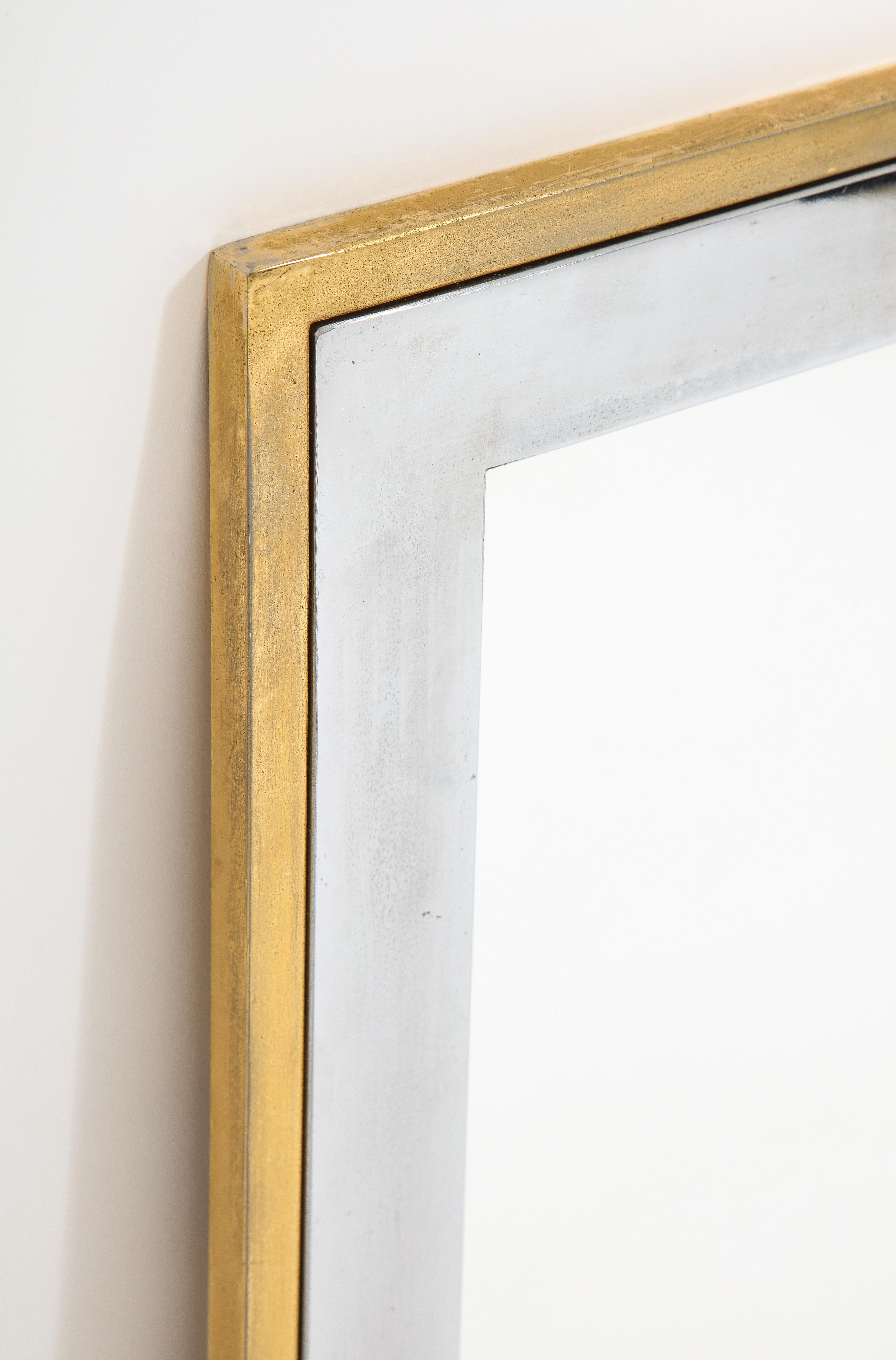 Elegant mirror in nickeled and brushed brass.