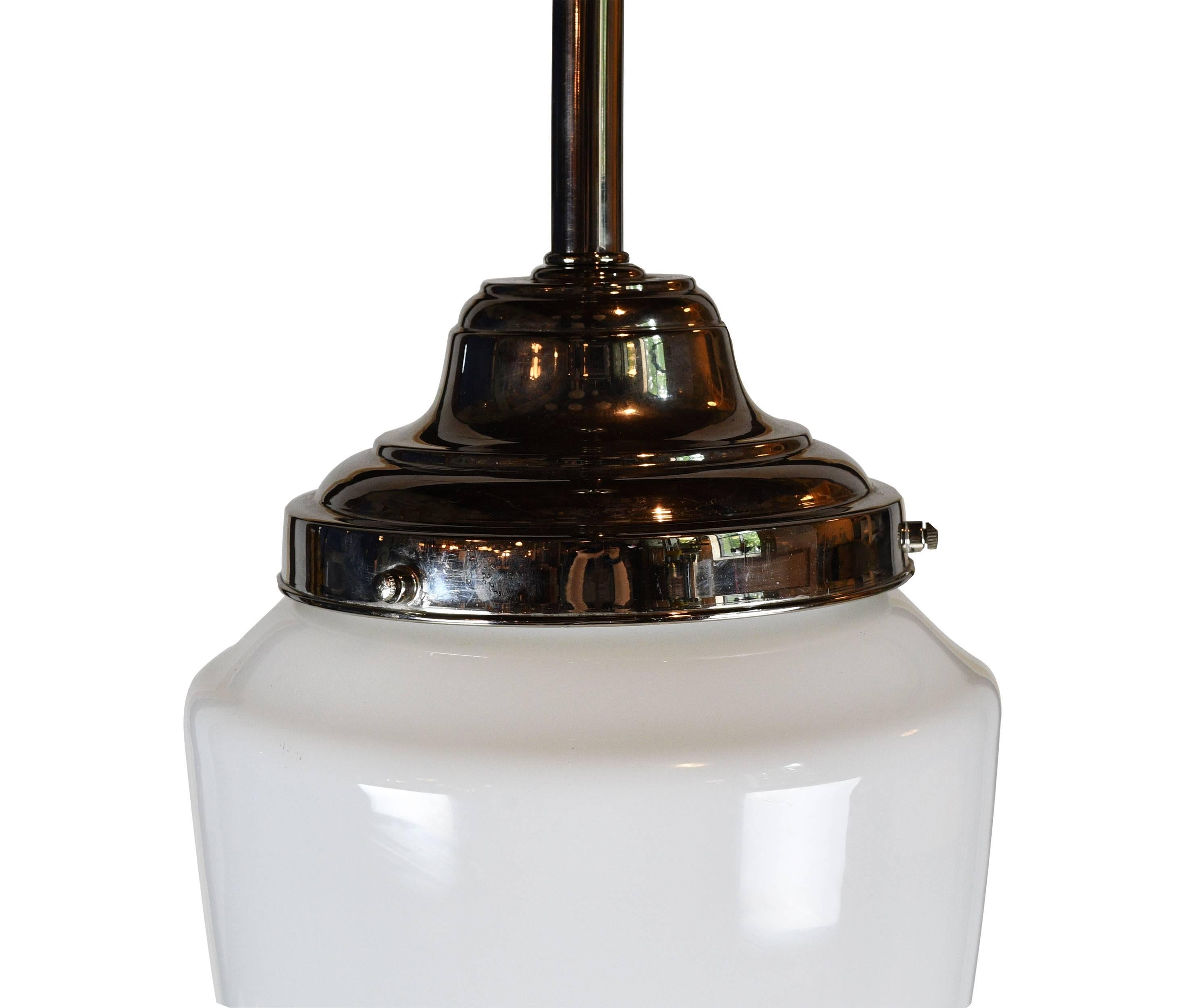 Unique, bullet-shaped schoolhouse pendants with milk glass shades that pair well with the nickel pendant to create a simple yet classy look. The shape of the shades is different than many other classic schoolhouse pendants, giving them a personality