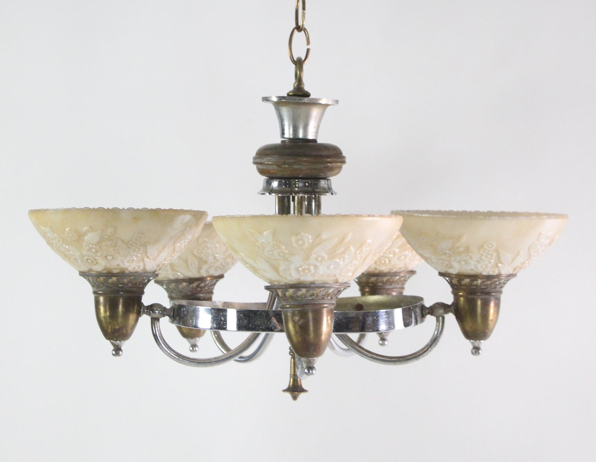 1930's Art Deco chandelier in nickel and brass with five glass shades. The glass shades have a raised floral pattern and are iridescent. Please note, this item is located in our Scranton, PA location.

  