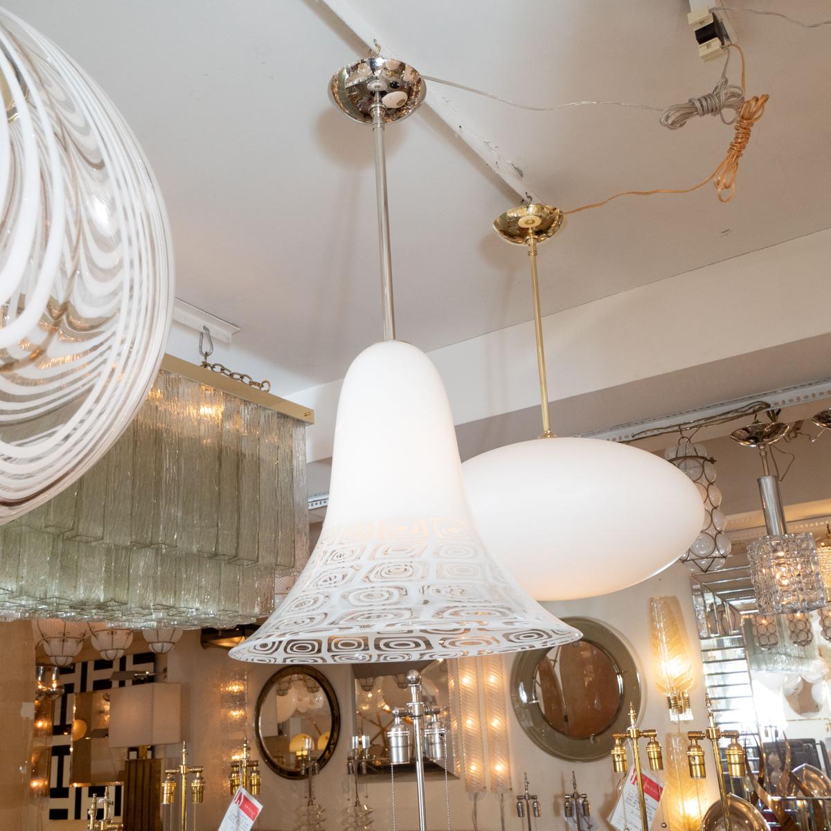Nickel pendant fixture with white and clear patterned Murano glass bell form shade.