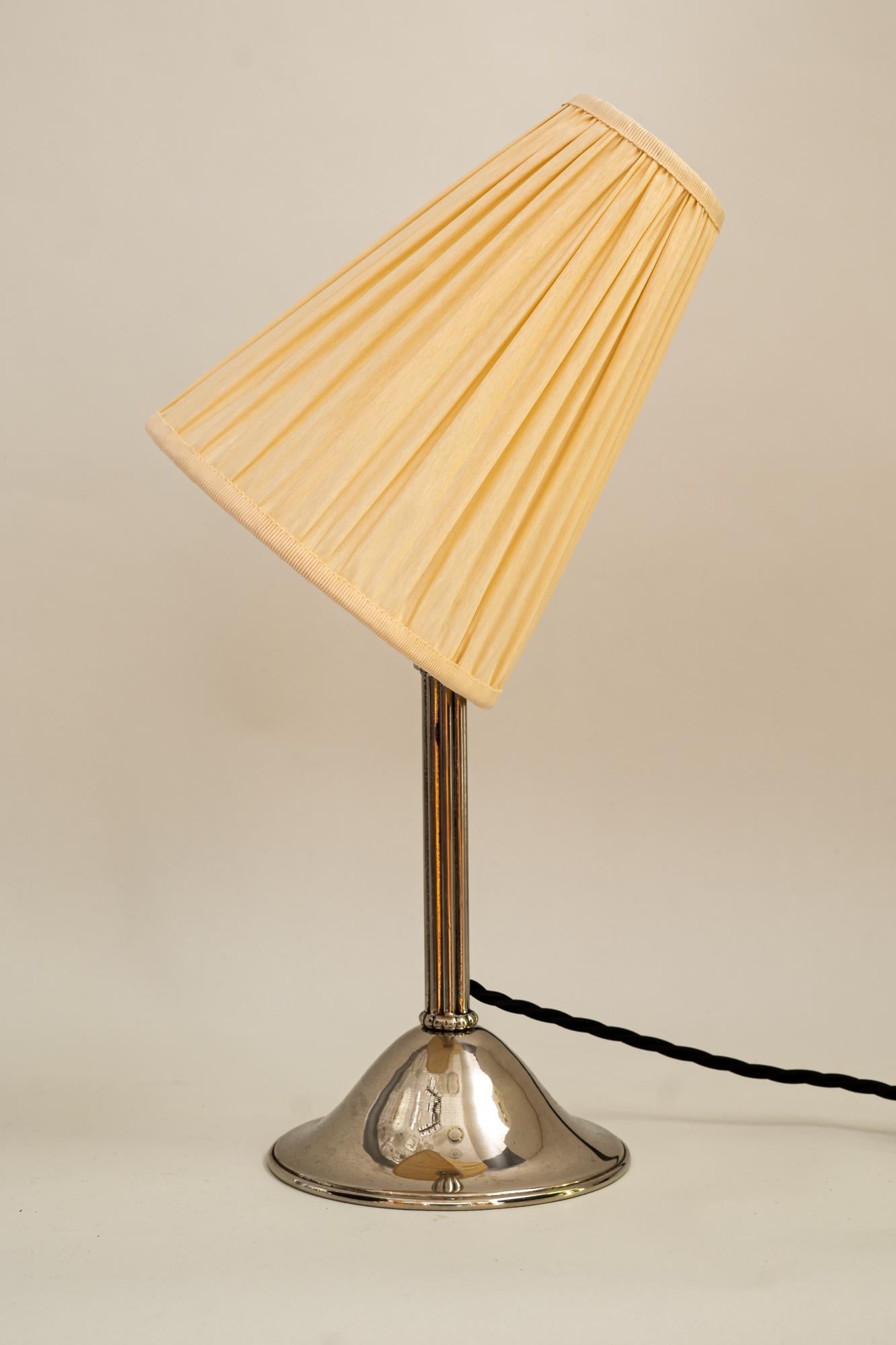 Nickel - plated art deco table lamp with fabric shade around 1920s
Original condition
The shade is replaced (new).