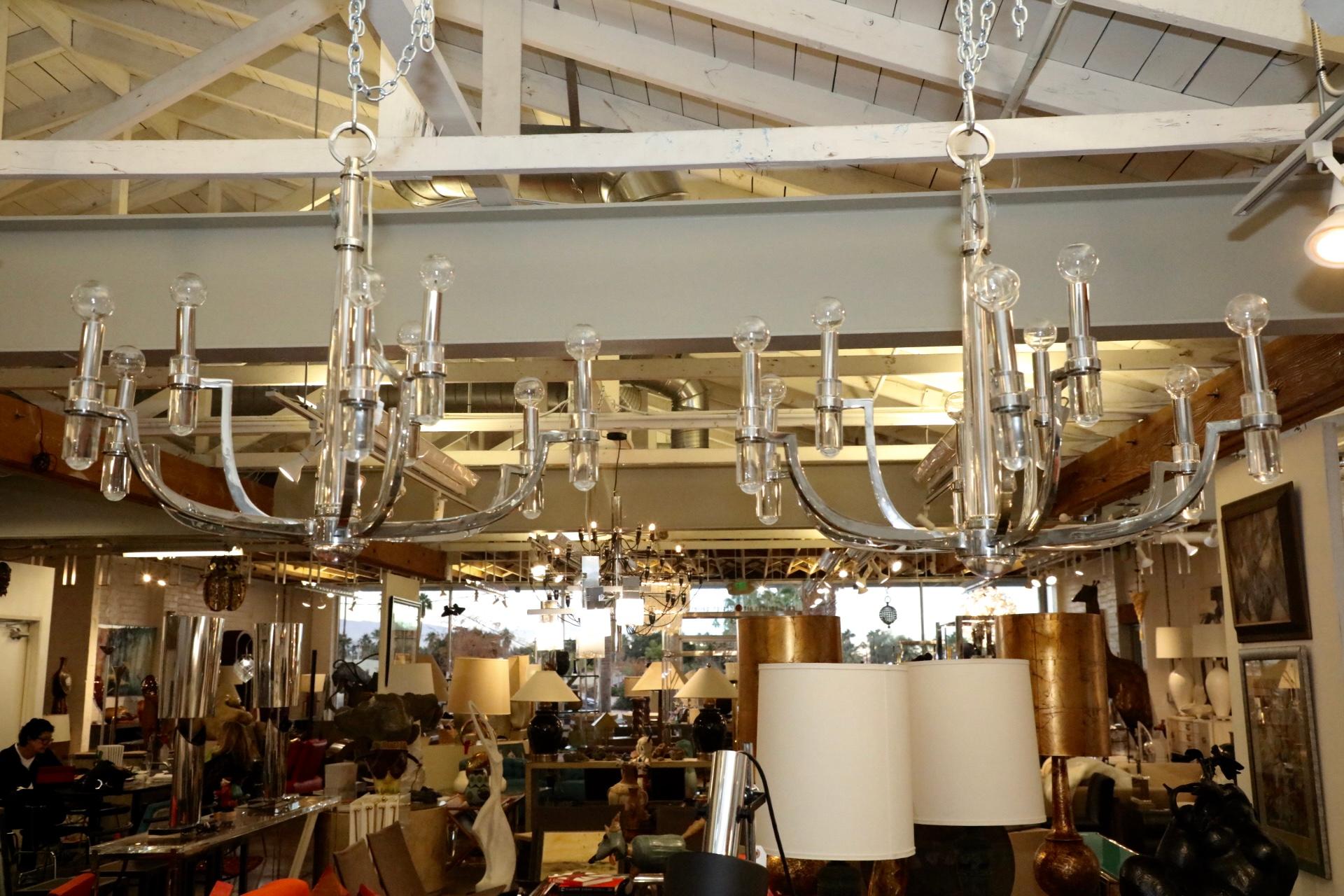 An elegant pair of Lucite glass and nickel-plated Brass chandeliers. The quality of these is extremely high. Nicely designed and in good condition, with only minor surface imperfections and marks. Sold each. One is shown lit.