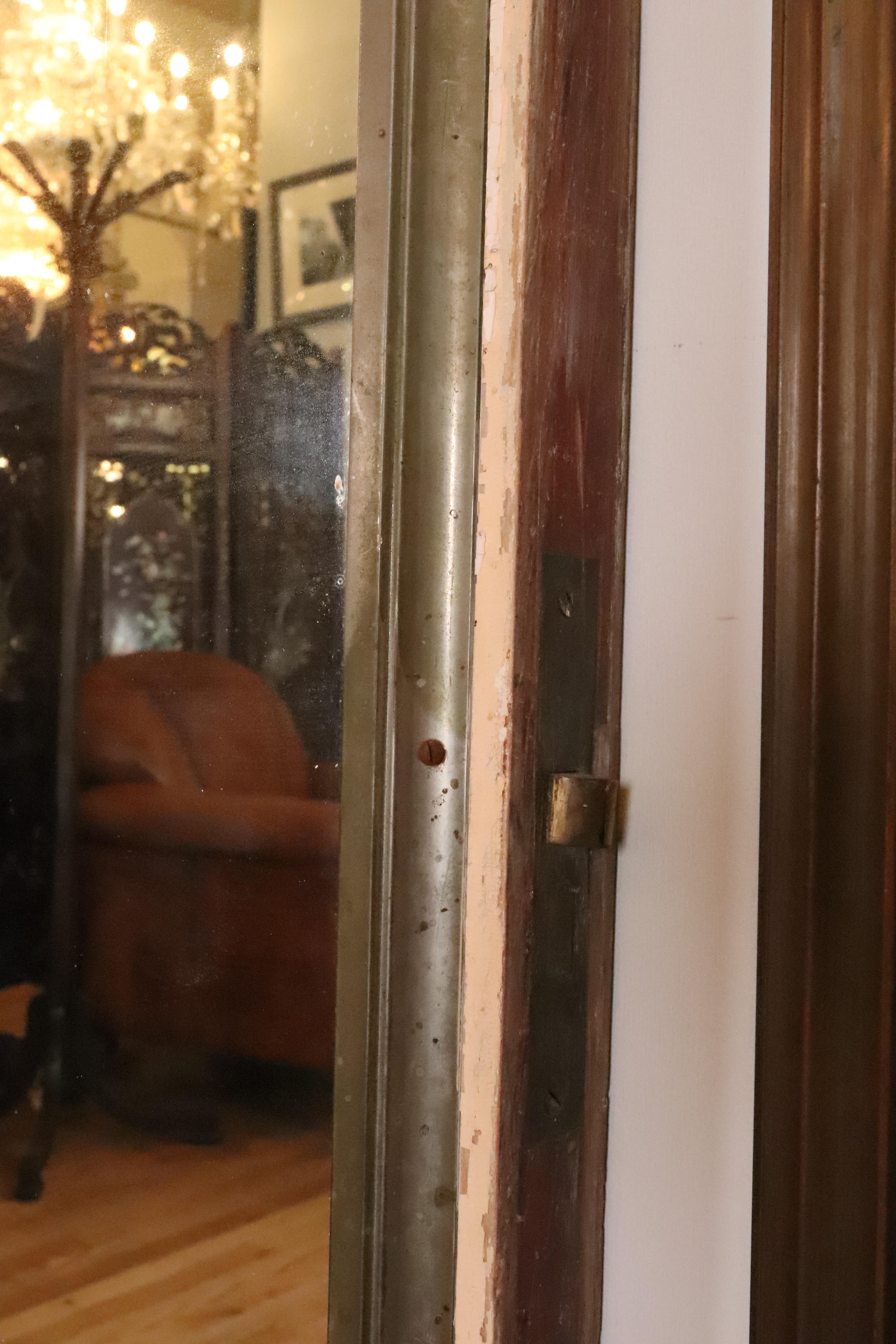 American Nickel Plated Brass Mirror Mounted on Cream Door For Sale