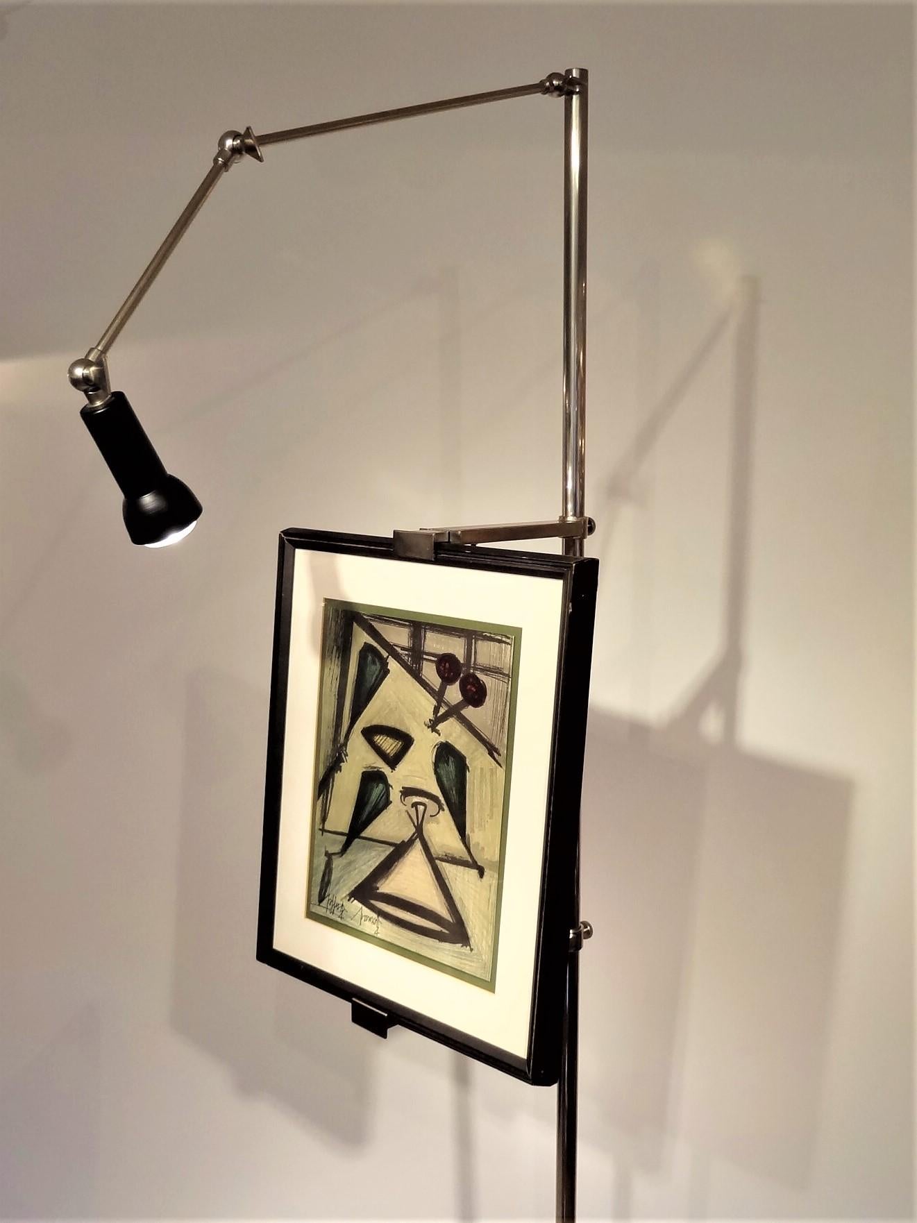 A nickel plated floor standing easel with articulating light and brackets designed by Angelo Lelii for the Italian company Arredoluce, Monza, Italy.