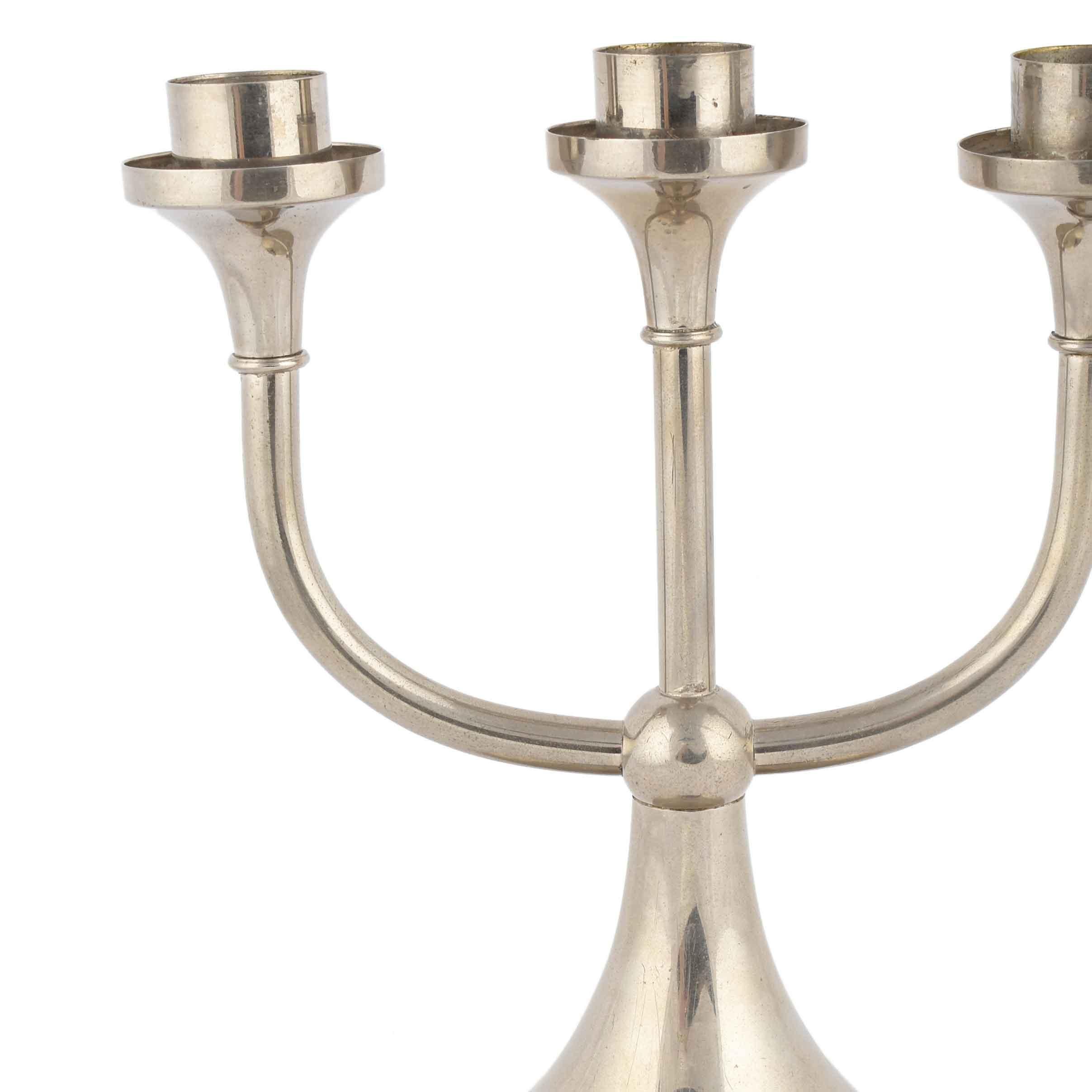 Vintage nickel-plated metal candleholder is an original decorative object realized between the 1920s and the 1930s.

Original nickel and metal. Realized by Kallmeyer & Harjes, Gotha. Made in Germany.

The mark of the factory is impressed on the