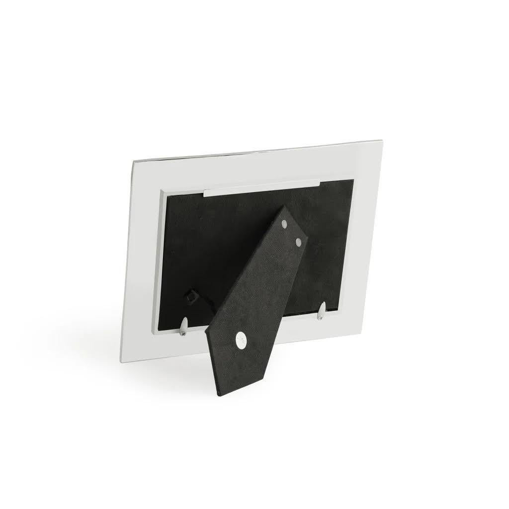 Nickel-plated metal frame imitating shagreen - hand-forged nickel-plated sharkskin-style photo frame with matt finish.

Description:

The Shagreen Collection interprets the subtle shimmer and grainy texture of natural stingray leather, offering a