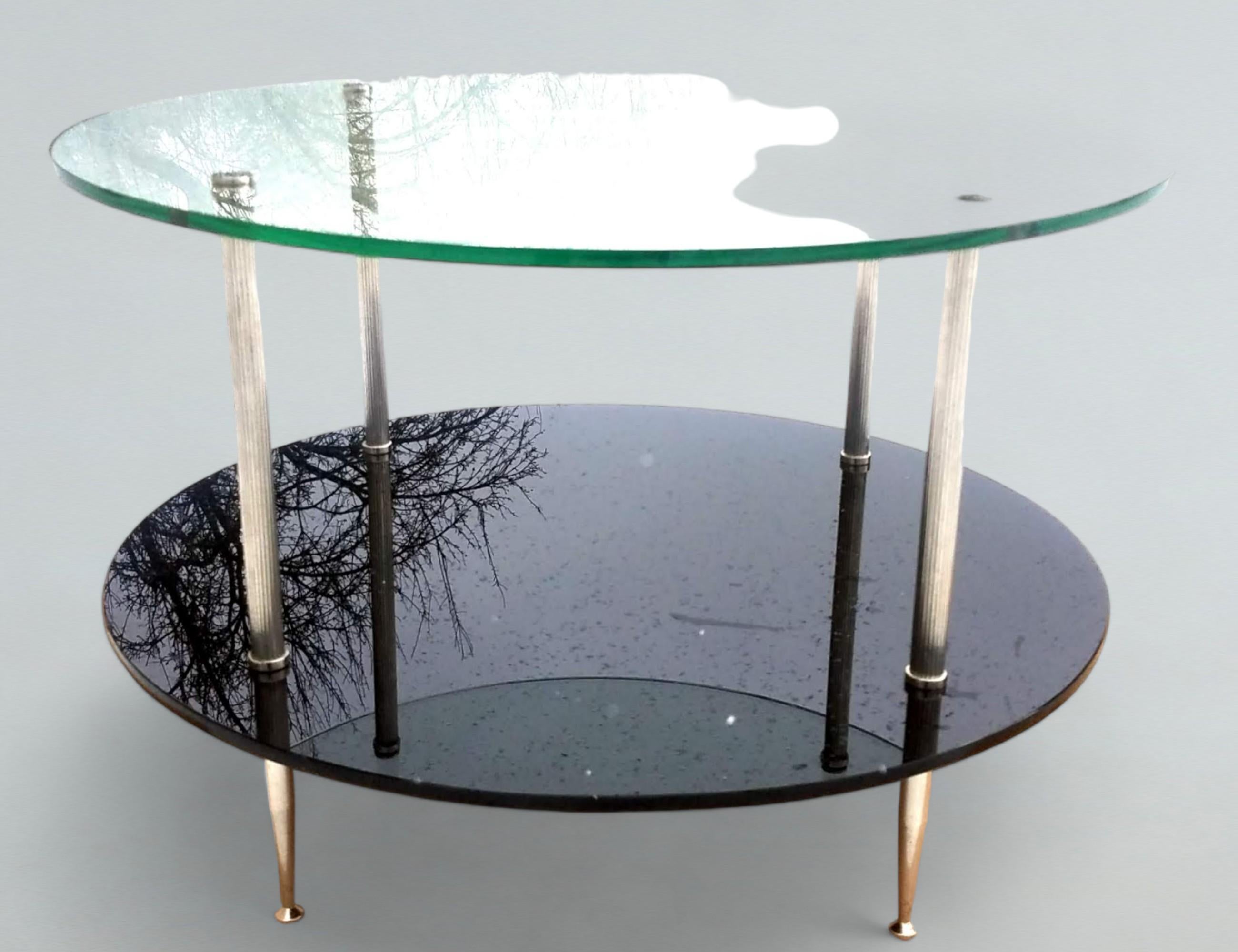 Maison Charles silver plated coffee table two tiered clear glass and black Vitrolite circular shelves.
The polished reeded legs end in slender points
The table is in excellent condition.