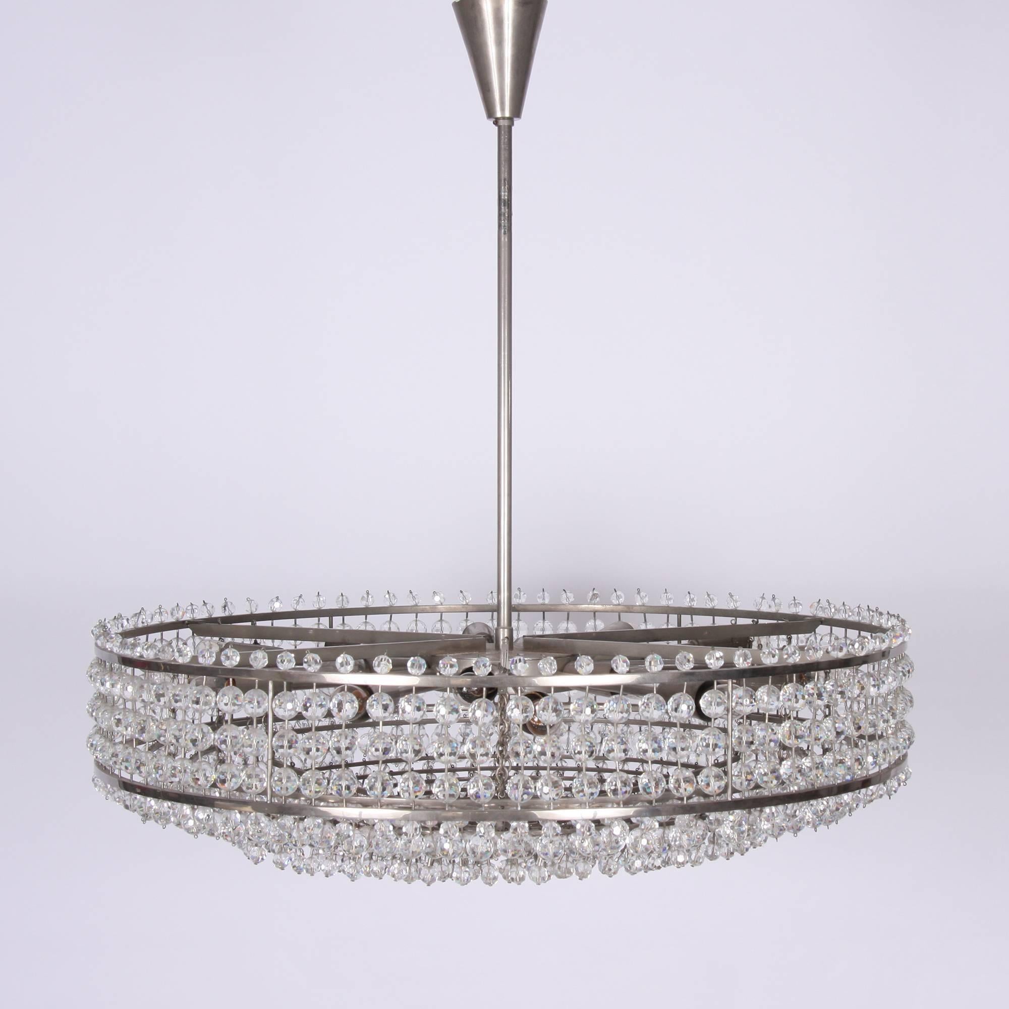 Nickel-plated round metal chandelier with facetted round glass drops. The drops are beautifully cut with a stunning light refraction. Two layers of lights in the interior with eighteen-light fittings altogether. Fully re-wired.