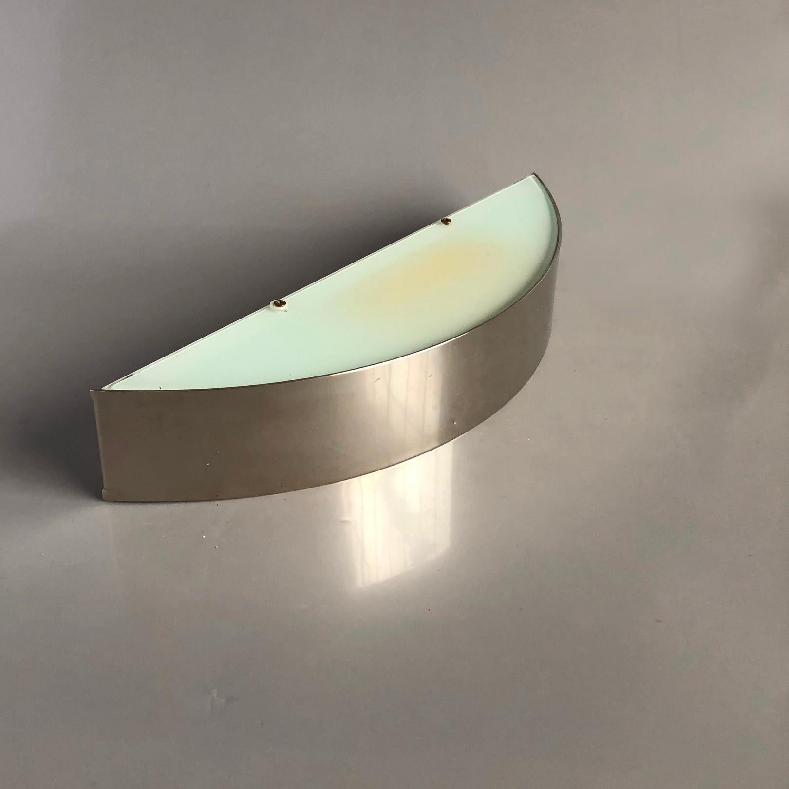 Sconces in half moon form. 
This Minimalist wall light was custom made in limited edition, and was not available on the market.

 
