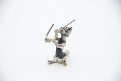 Nickel plated silver miniature cat with drumsticks